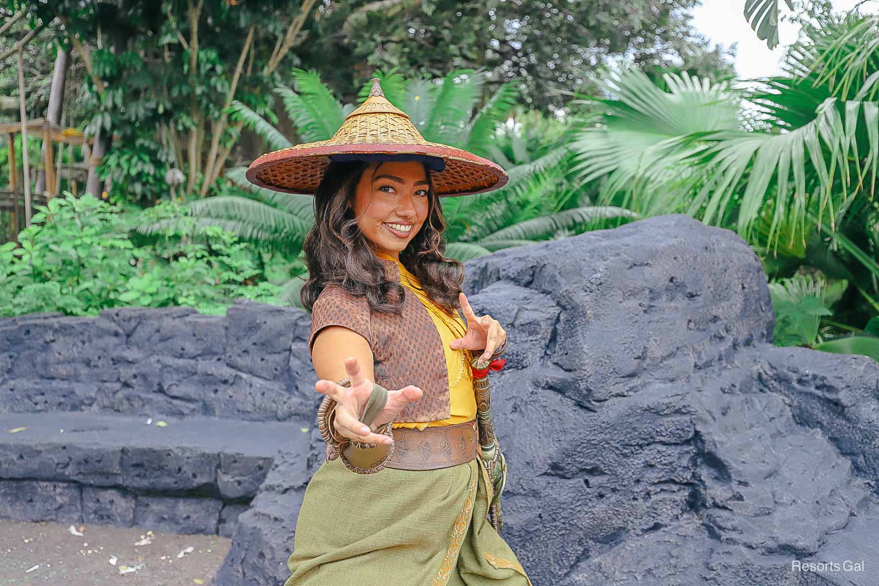 Raya poses with arms out. 