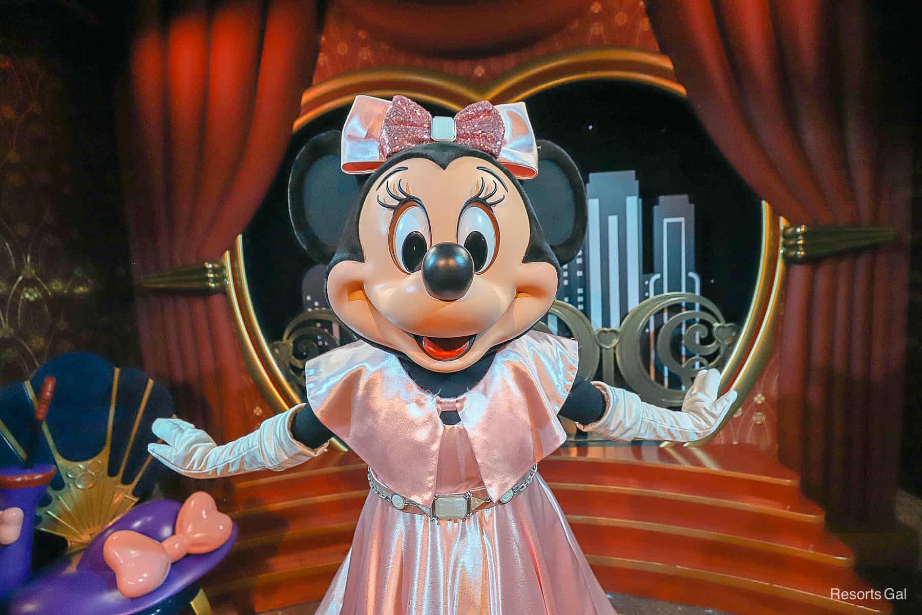 Close up of Minnie Mouse in pink satin dress 