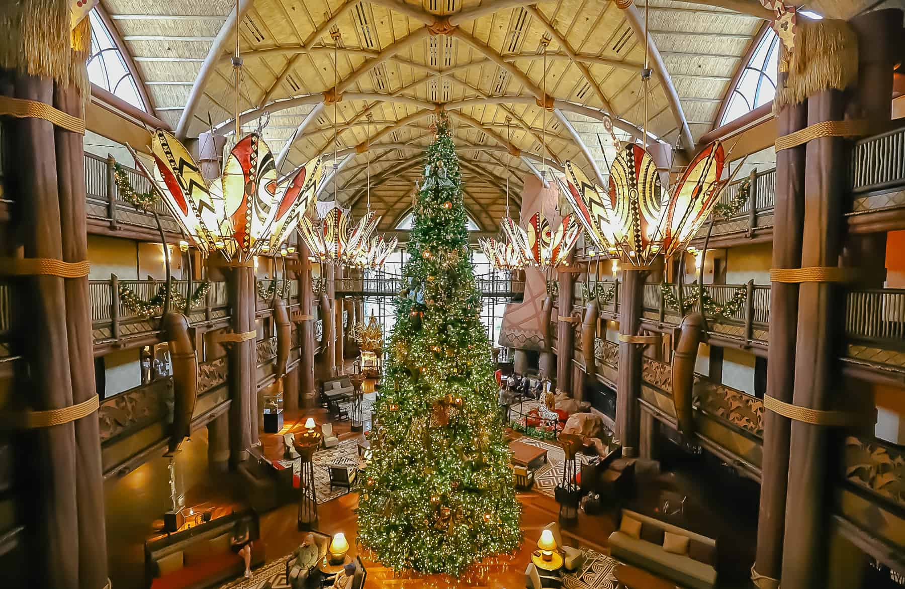 A photo of the Christmas Tree at Animal Kingdom Lodge taken from an upper level. 