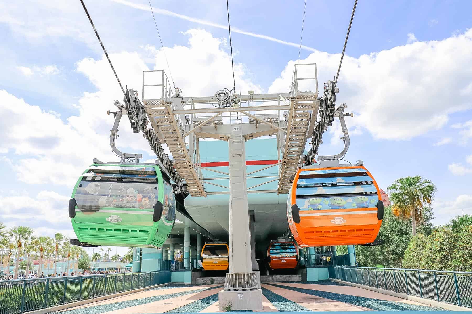the Disney Skyliner with a green and red gondola 