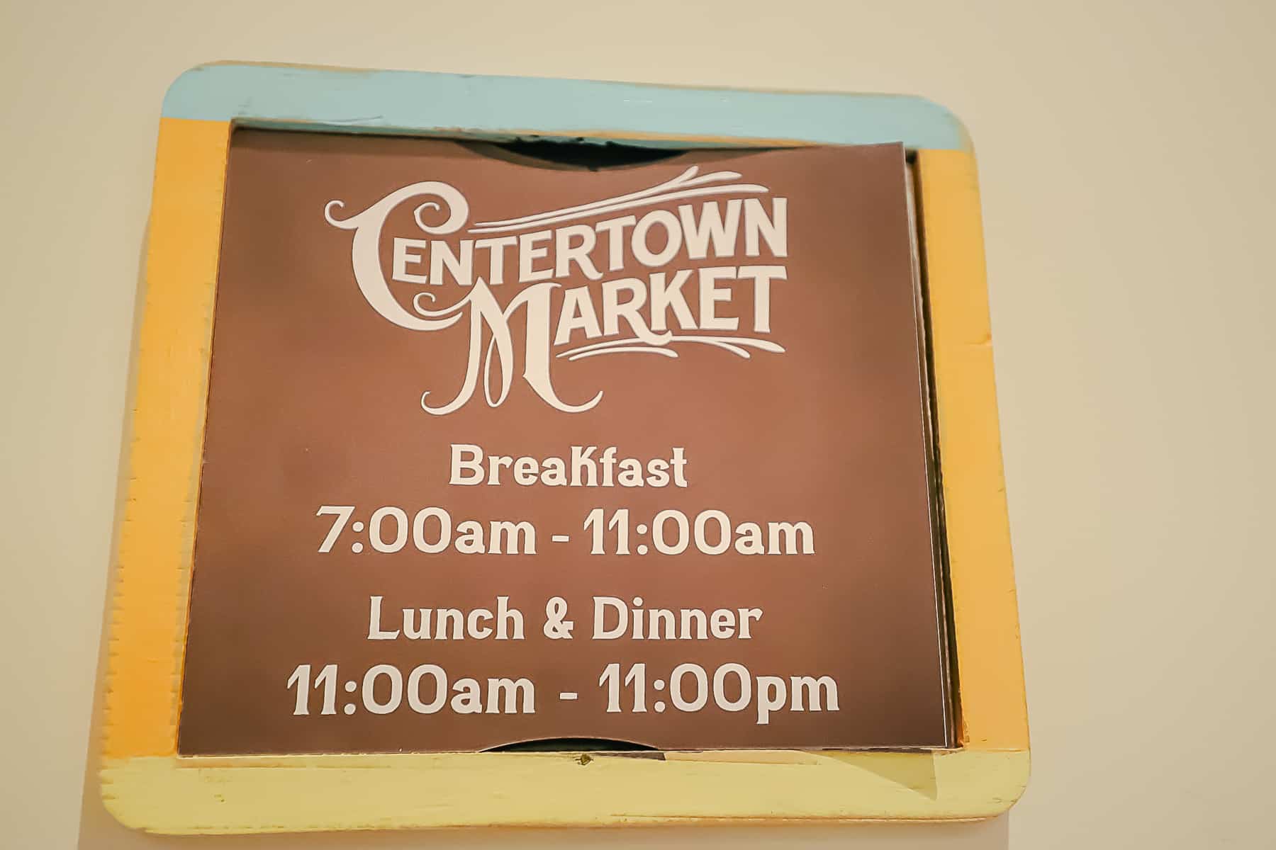 a sign that lists the hours for breakfast, lunch, and dinner at Centertown Market 