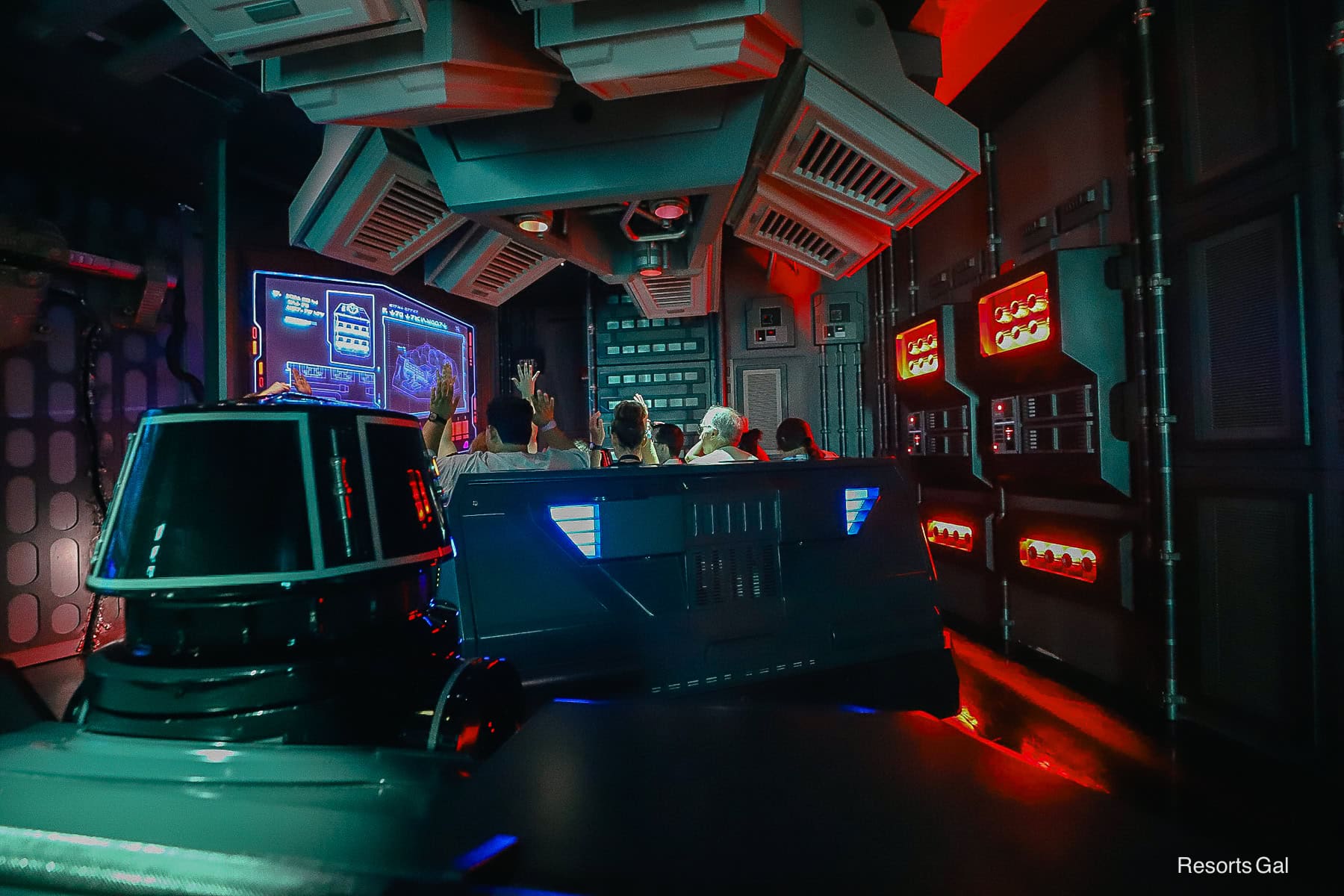 on board the ride with guests hands in the air for a seatbelt check 