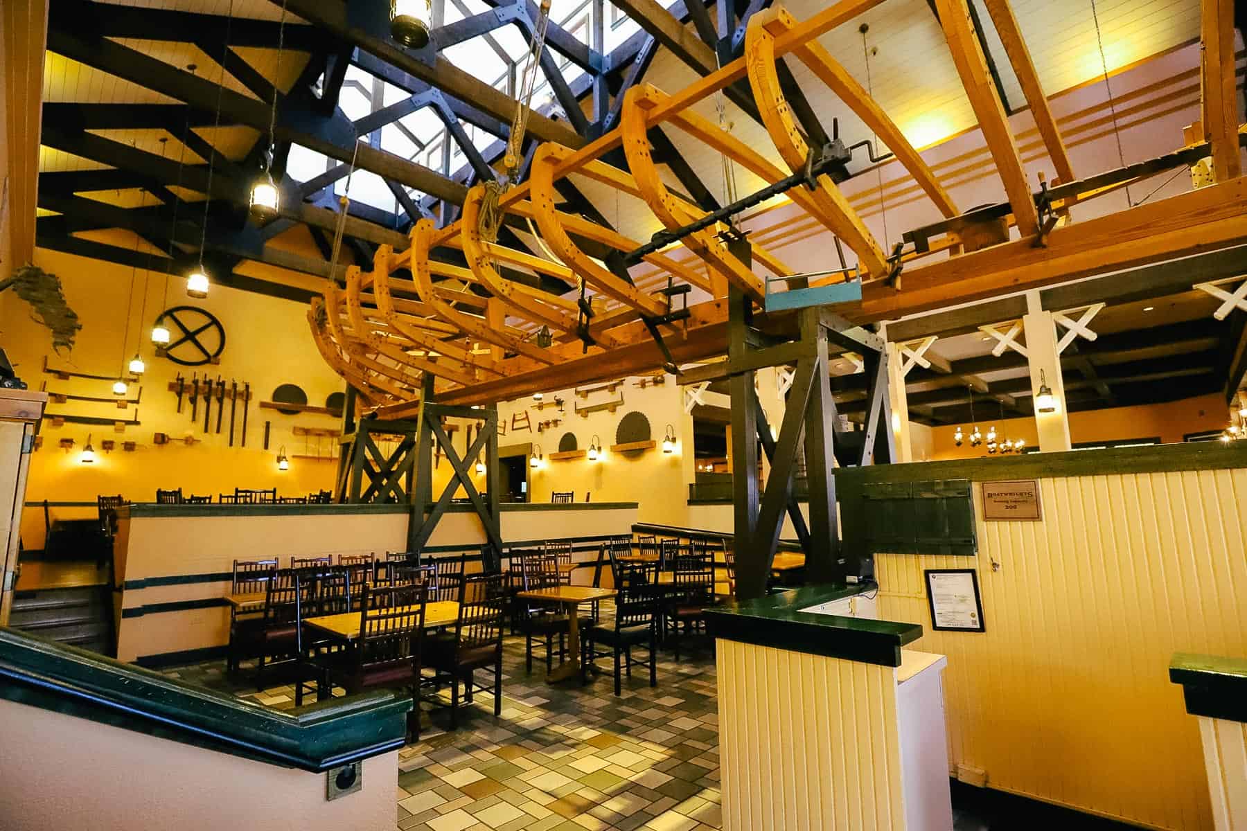 the hull of a boat hangs over the main seating area in Boatwright's at Port Orleans Riverside 