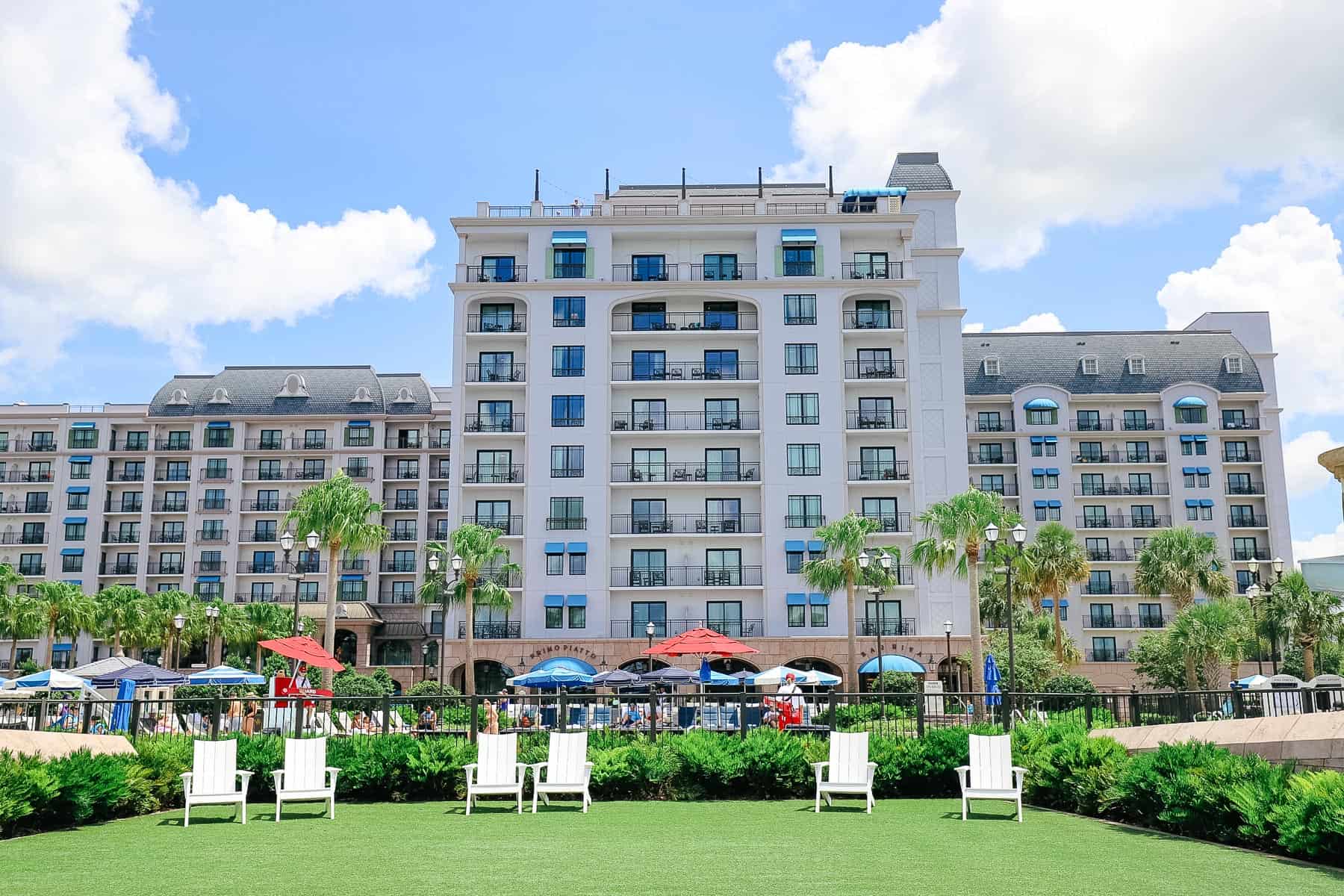 Disney's Riviera with the green lawn and white lawn chairs 