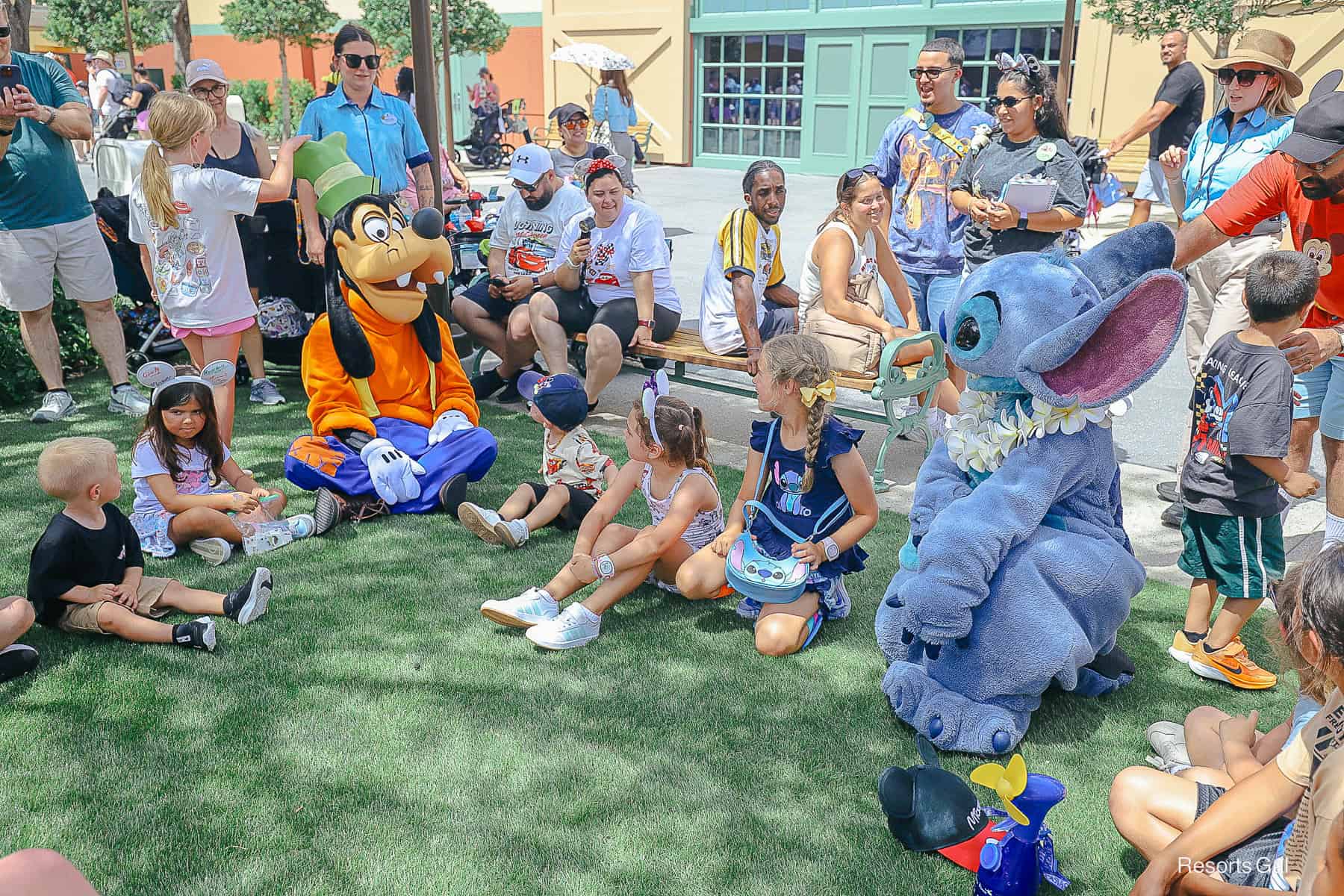 Goofy and Stitch playing Duck, Duck, Goose with guests