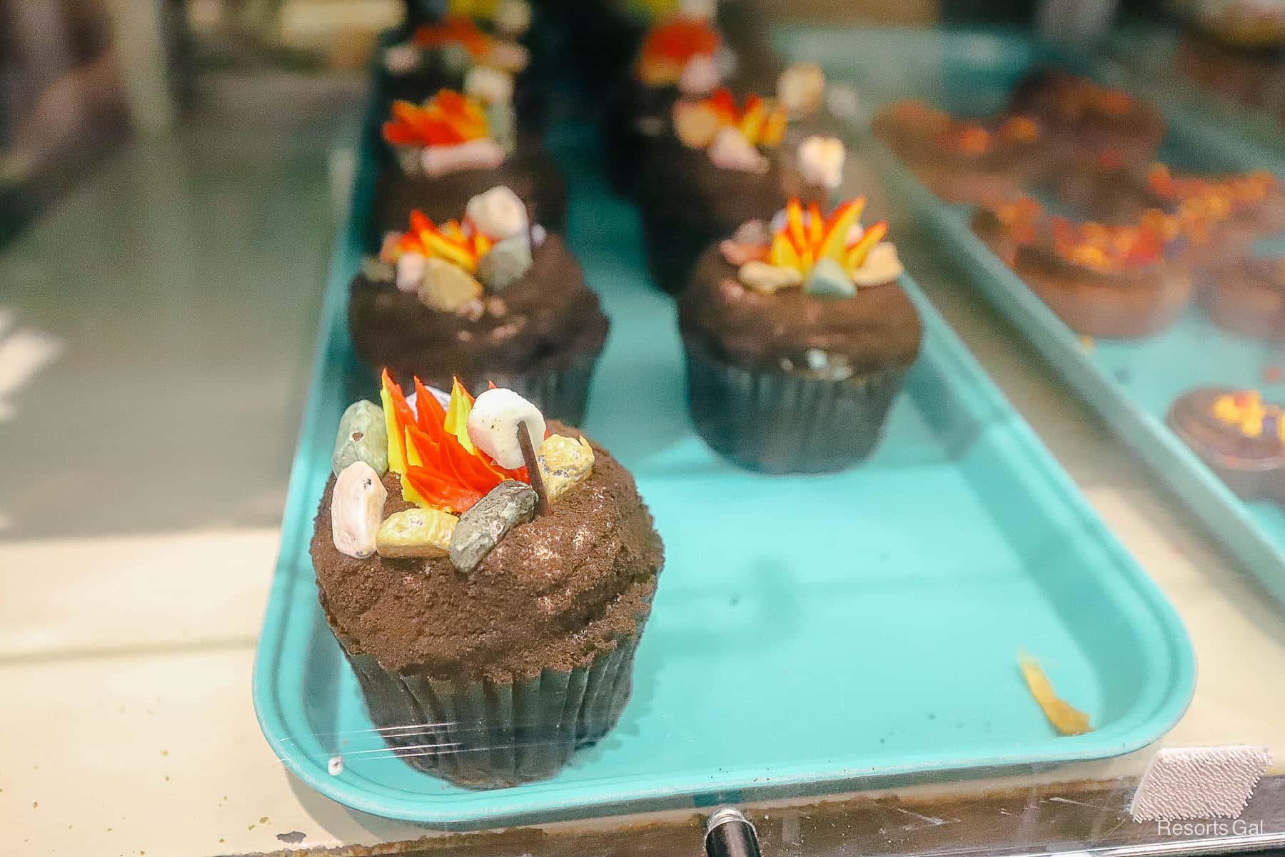 the Campfire S'more cupcake is chocolate and looks like a marshmallow is roasting over the fire on top of it 