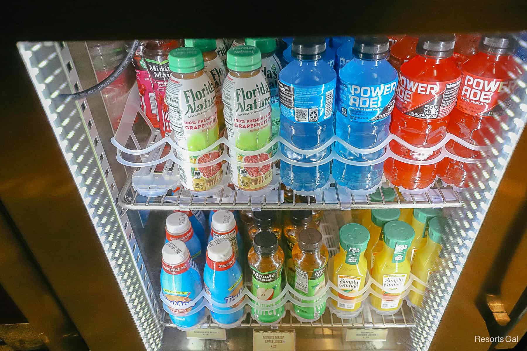 a refrigerated case with sports drinks and juices 