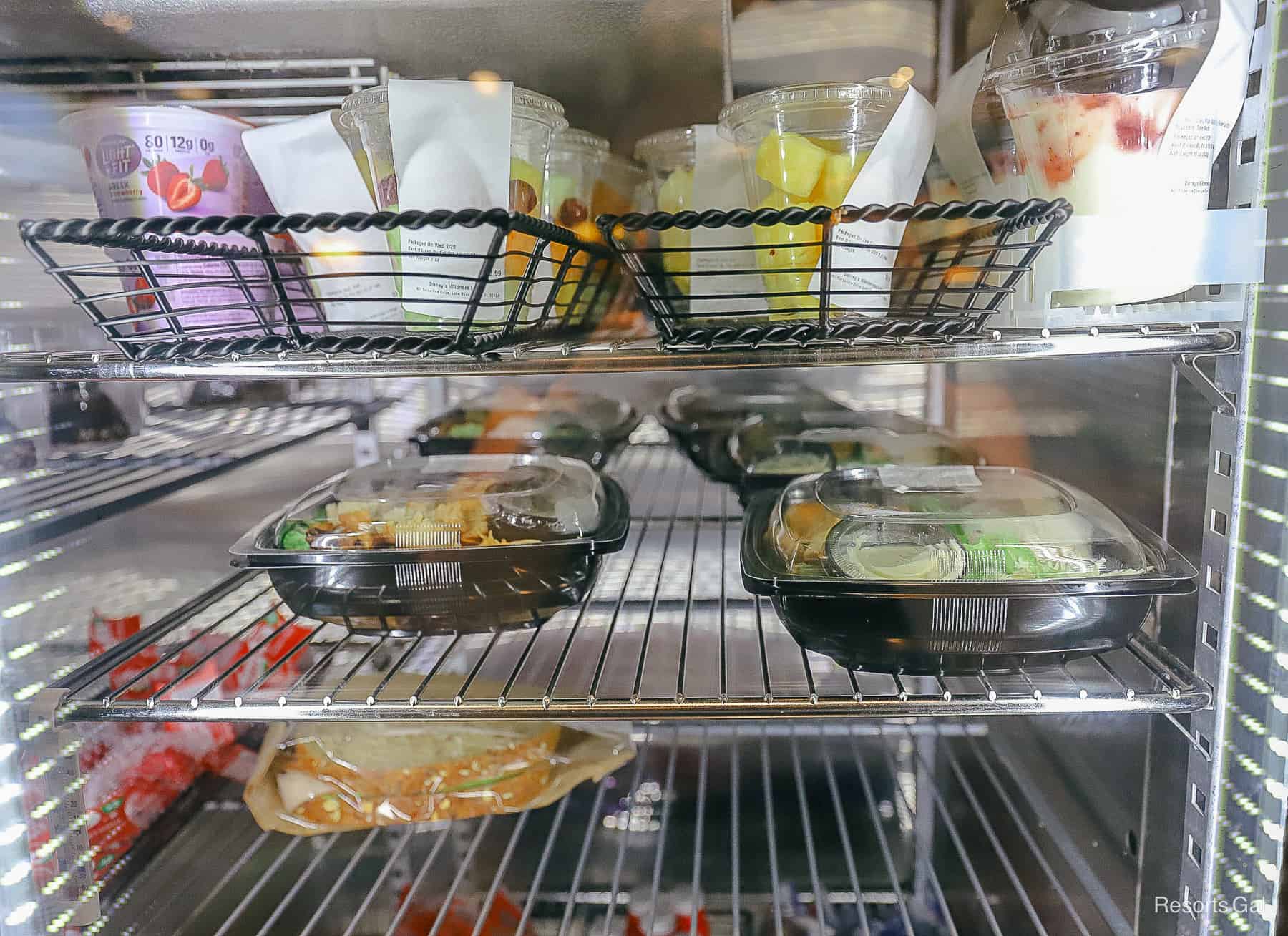 a case with fresh fruit, parfaits, yogurt and premade sandwiches and salads