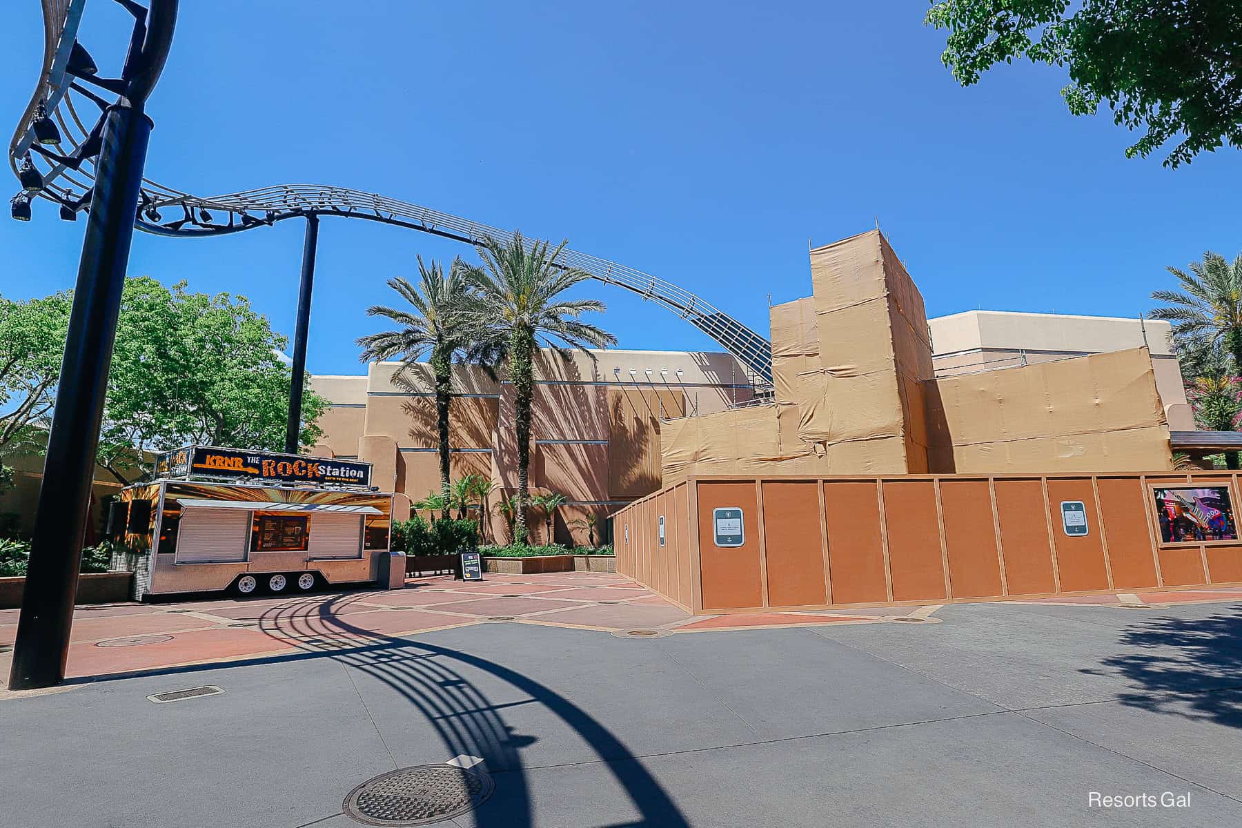 a construction wall and tarp covering the entrance of The Muppets Rock 'n' Roller attraction at Hollywood Studios.