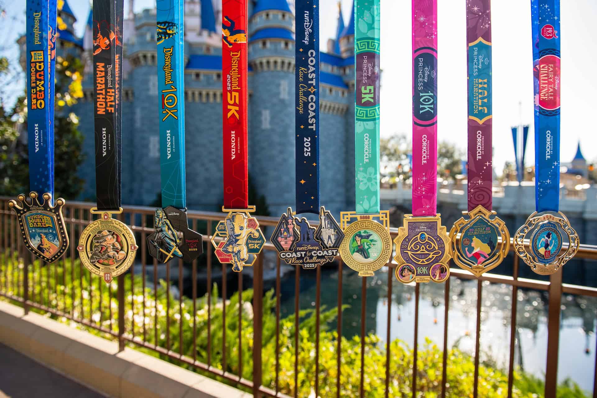runDisney medals in front of the castle