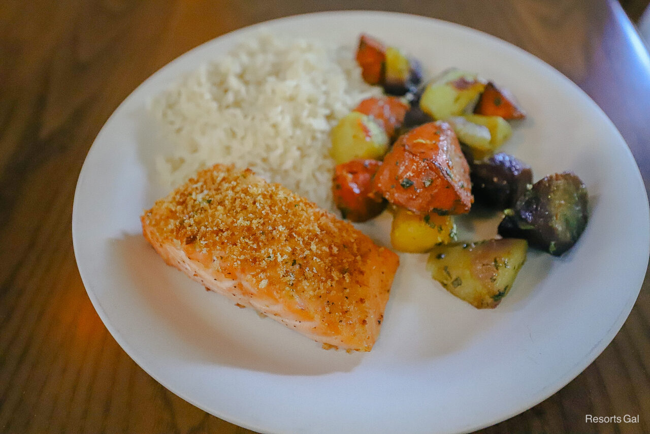 a plate with salmon, rainbow carrots, and rice 