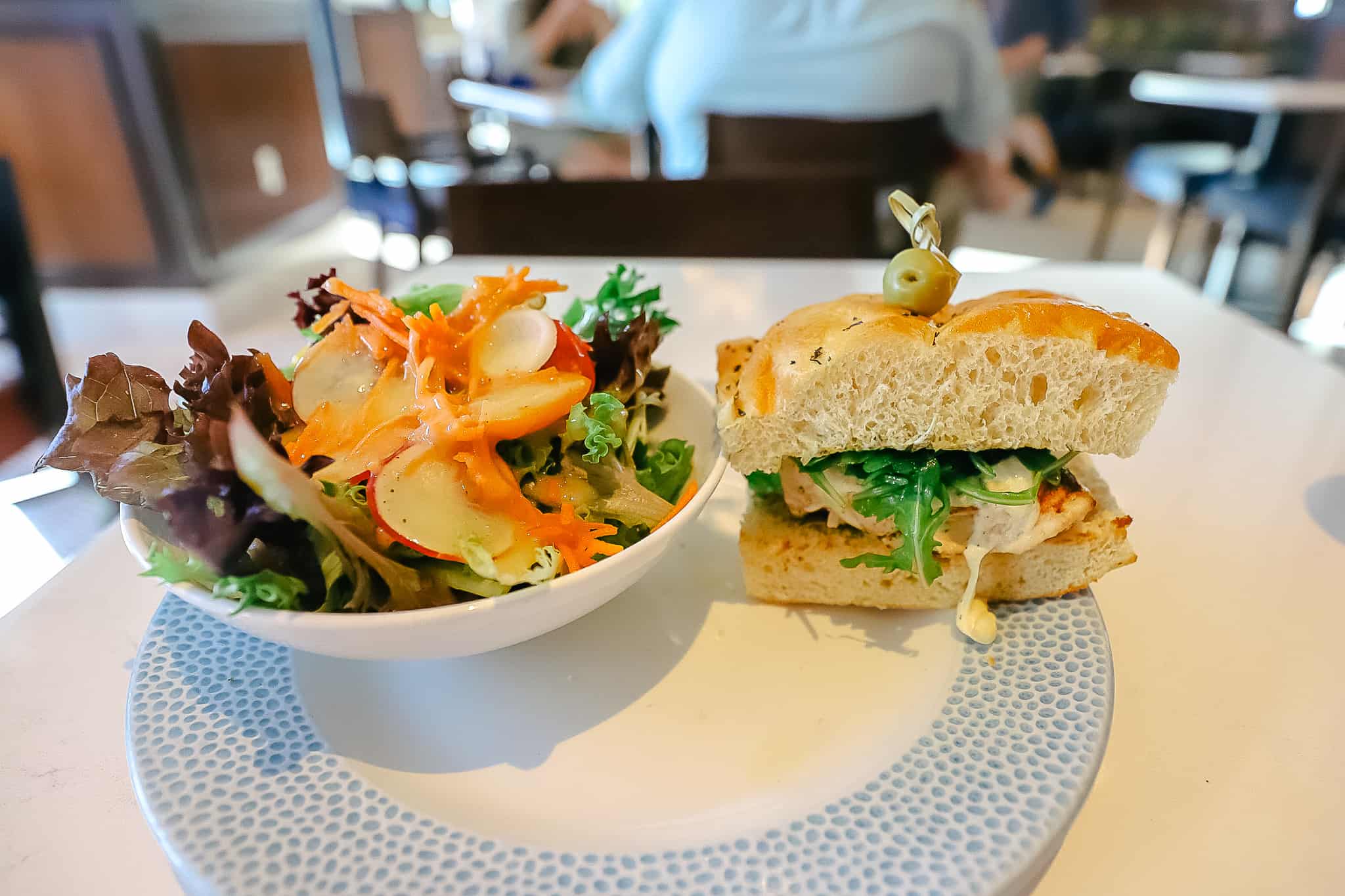 grilled chicken sandwich with a salad 