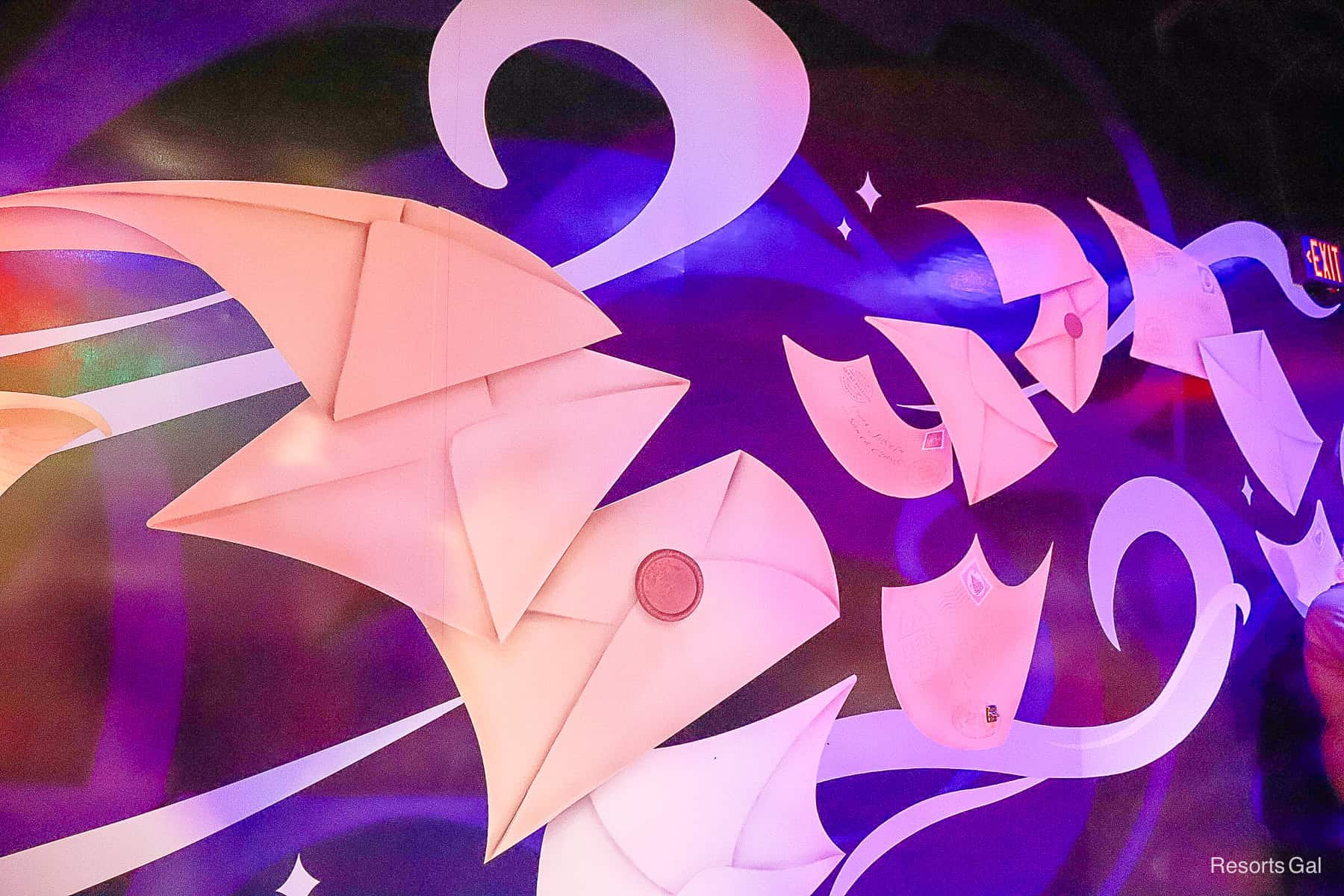 a feature wall painted to look like letters to Santa flying through the air 