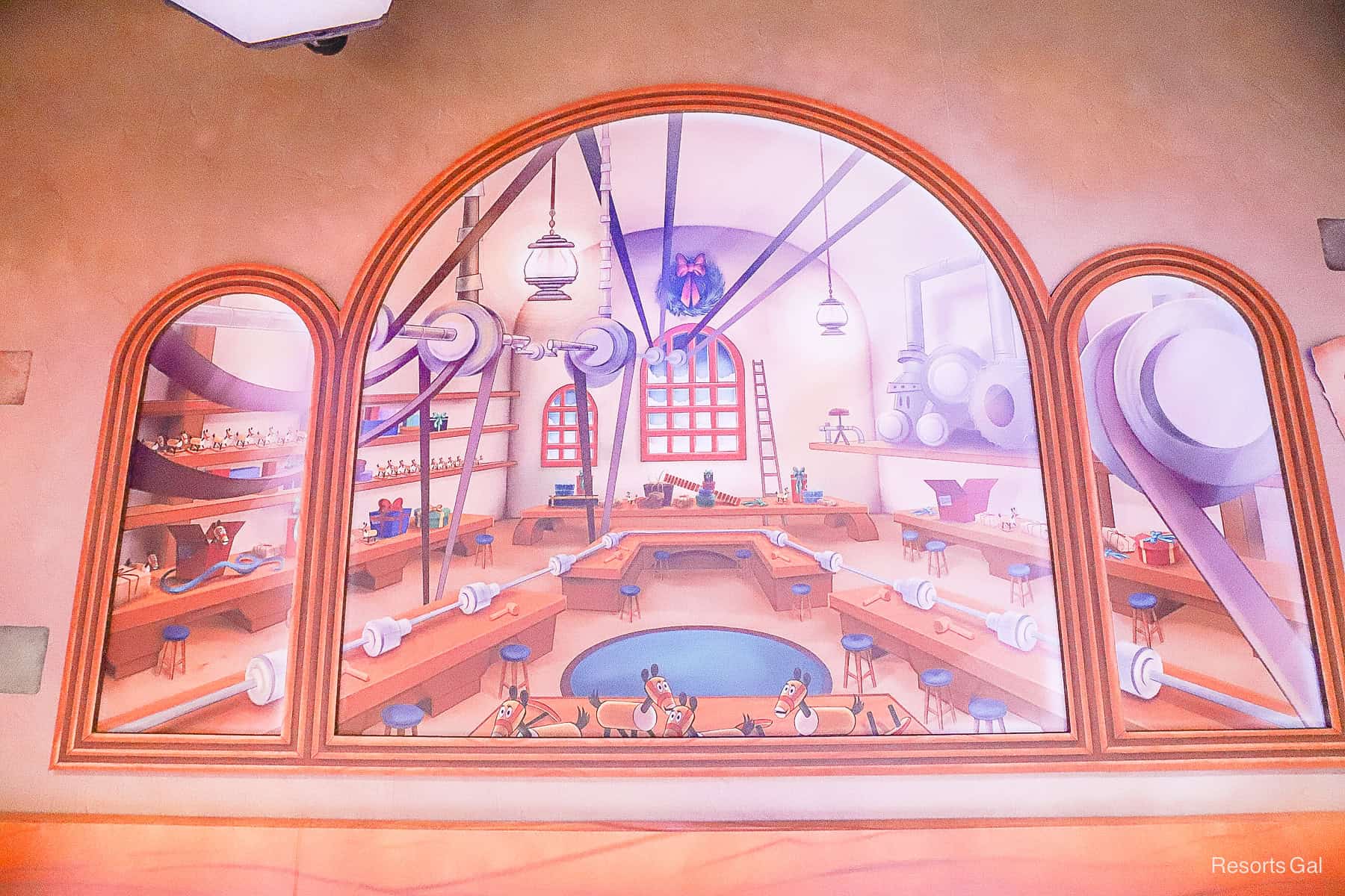 a mural of Santa's workshop painted in the queue 