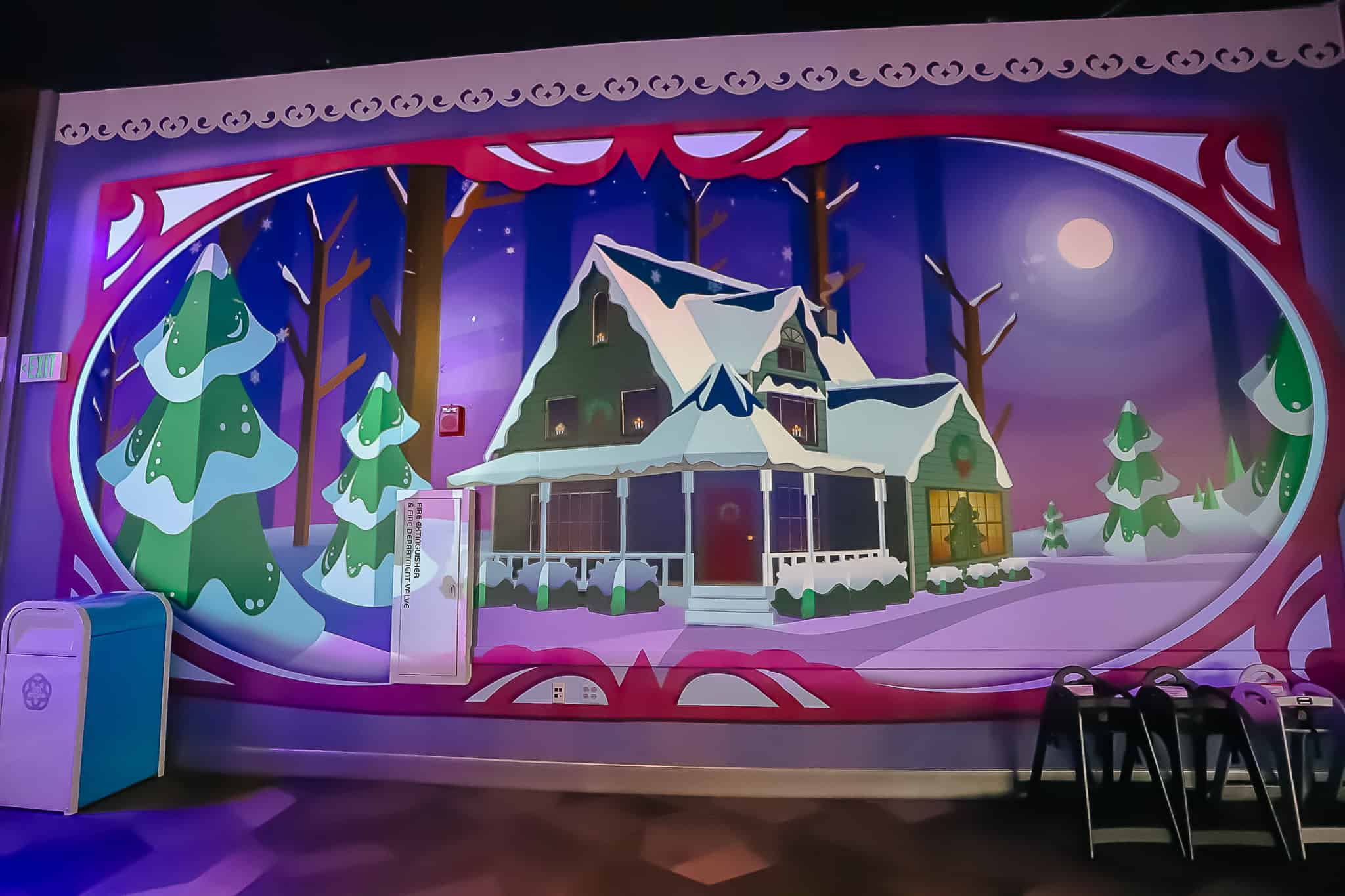 A decorative projection screen that displays a house covered in snow during the holidays. 