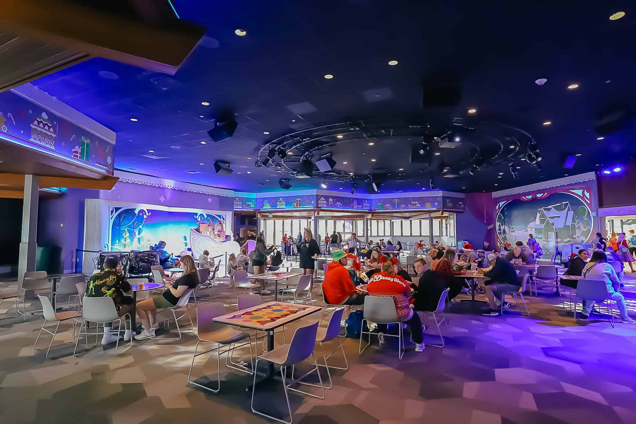 Guests sitting at tables and chairs inside the Odyssey Pavilion. 