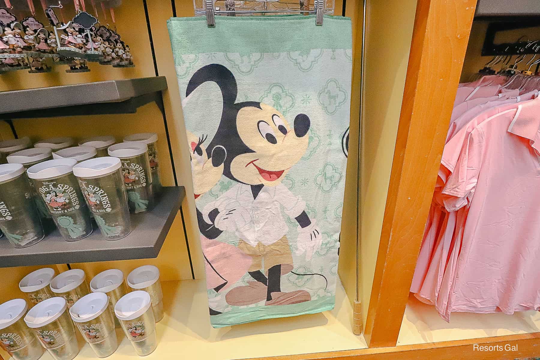 a beach towel with Mickey and Minnie Mouse and a mint green backdrop at Saratoga Springs 
