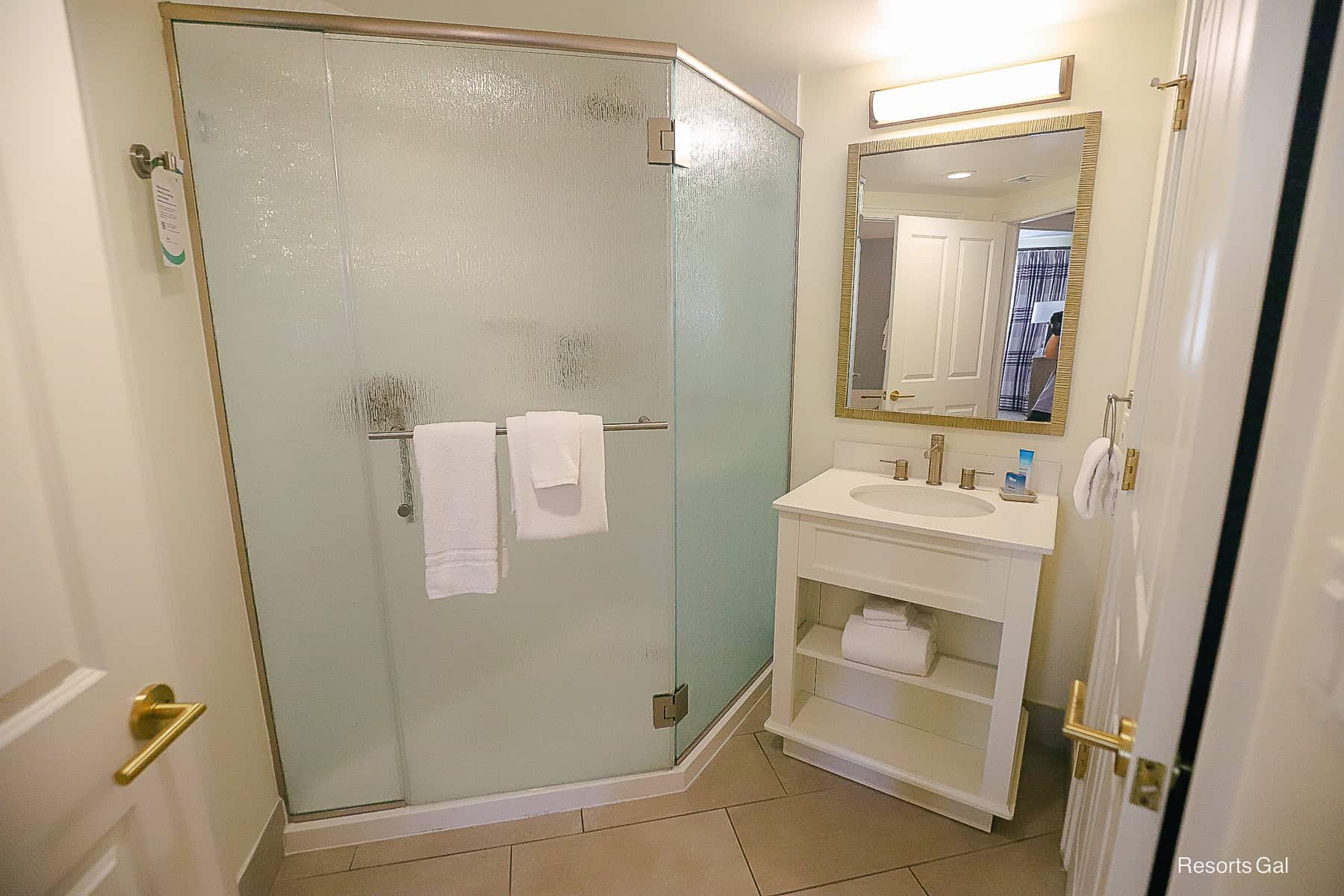 a stand alone shower with single vanity