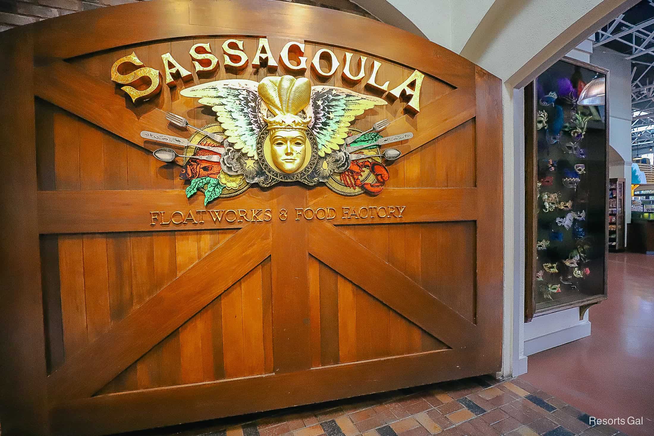 a large wooden door that says Sassagoula Floatworks & Food Factory in Gold Letters 