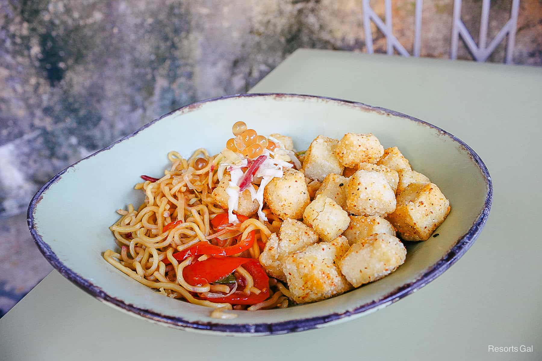 a bowl with noodles, veggies, and tofu 