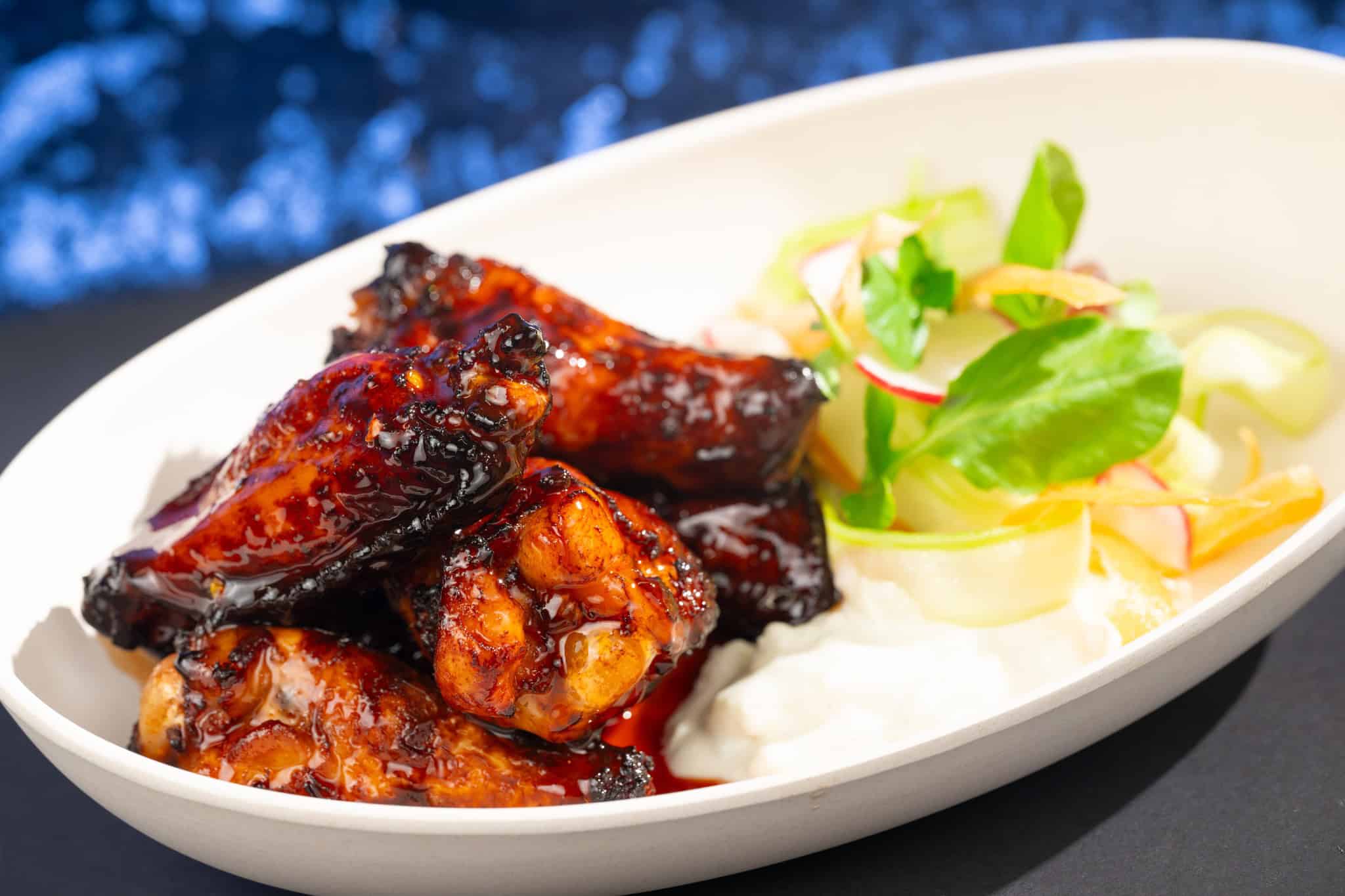 an order of chicken wings with a side salad from Sci Fi Drive In Theater 