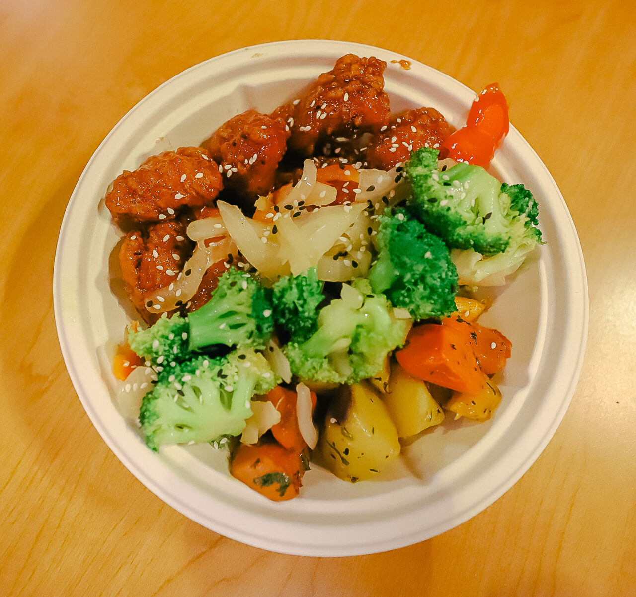 a bowl of sesame stir fry chicken with vegetables 
