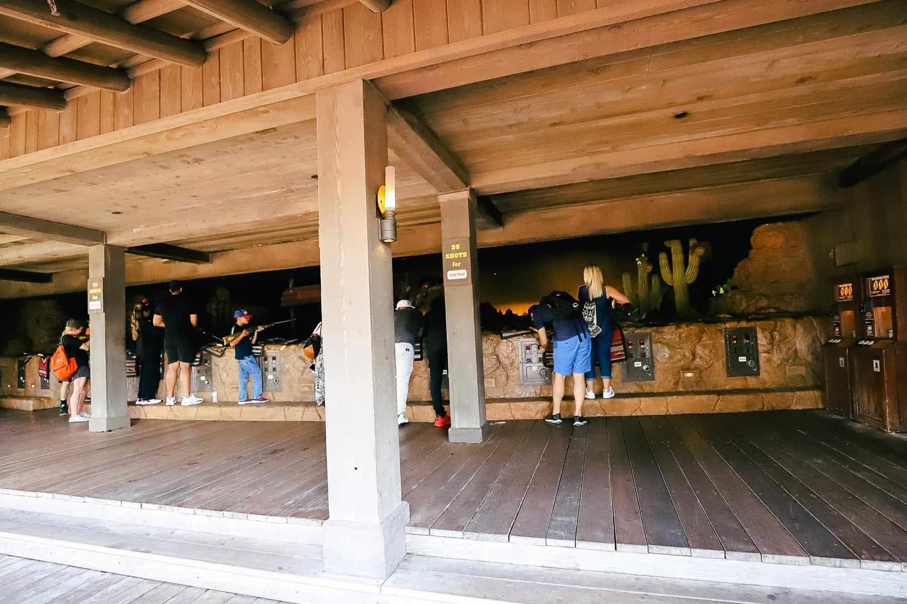Guests participating in the shooting range at Frontierland Shootin' Arcade. 