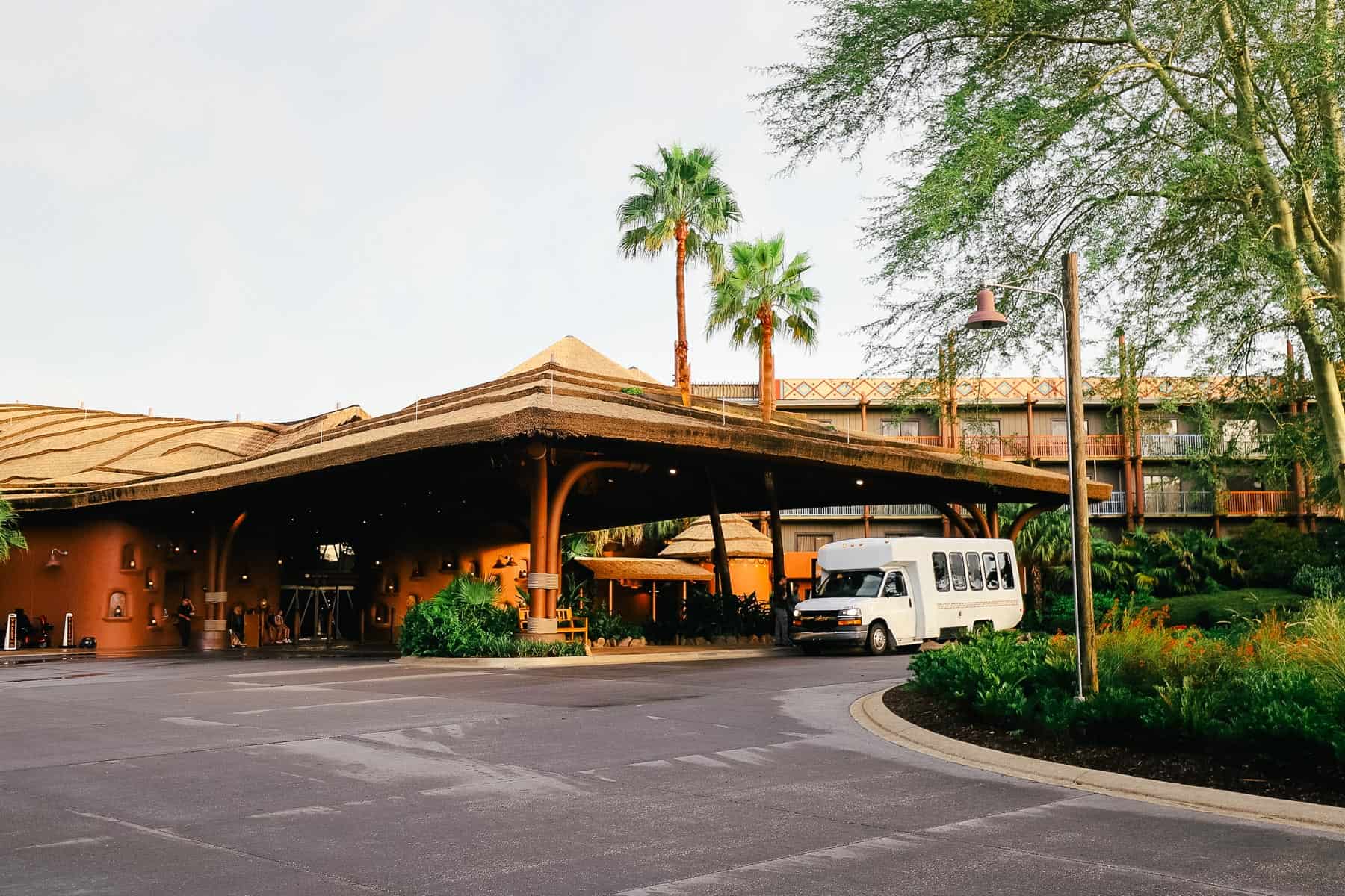 a white shuttle van sitting outside the Kidani Village Lobby 