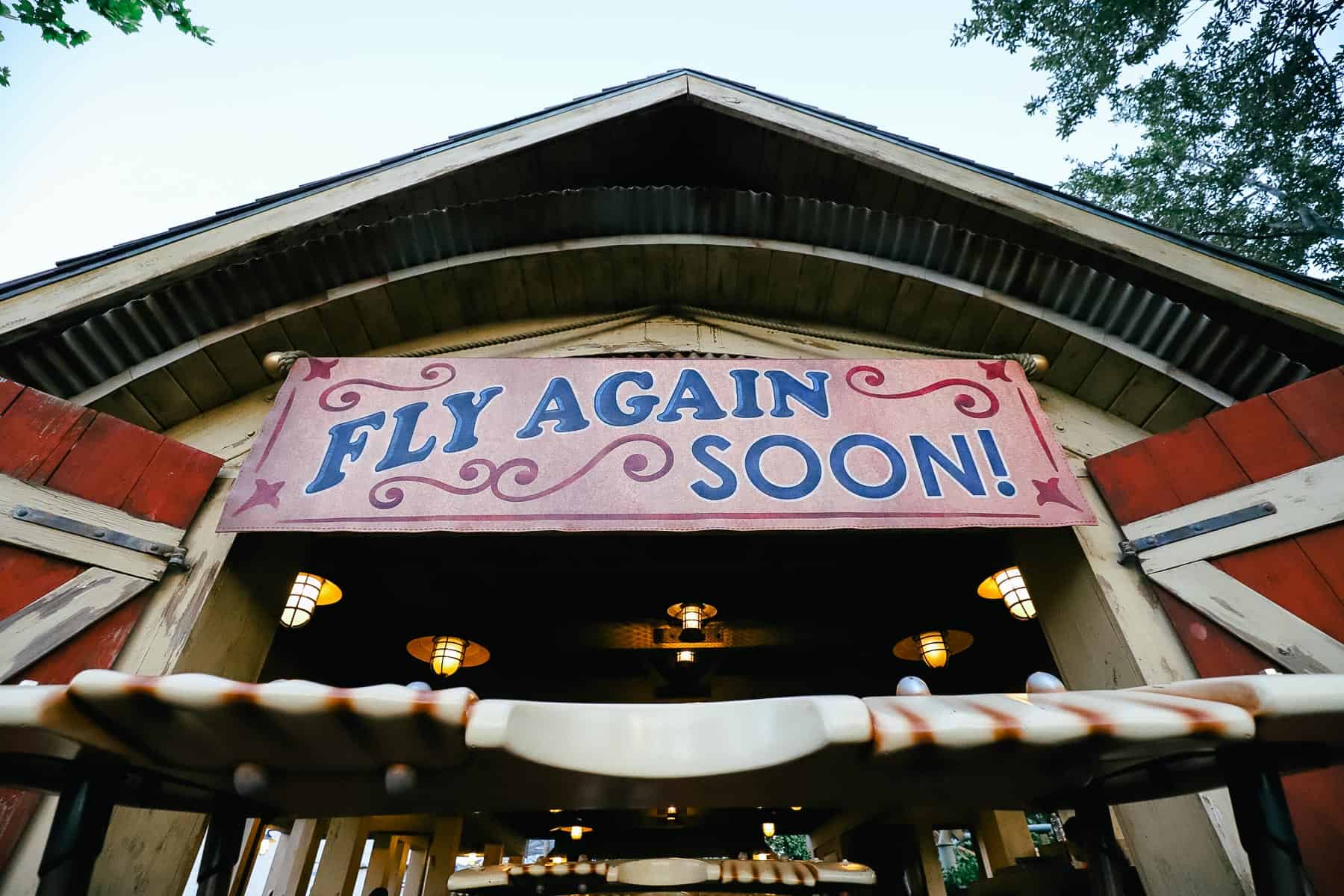 A sign that reads Fly Again Soon at the end of the ride. 