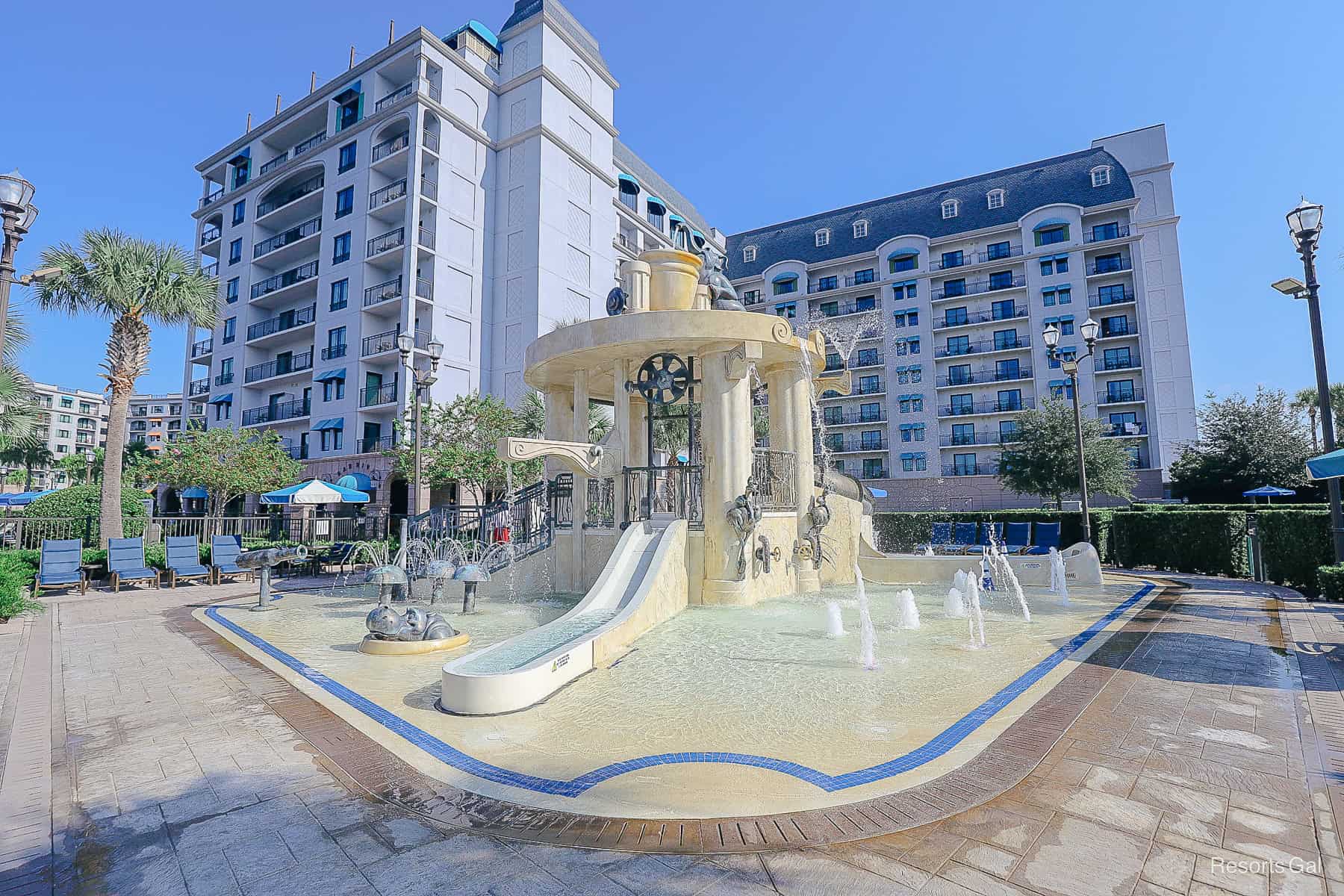 a small slide that goes straight down into the splash pad 