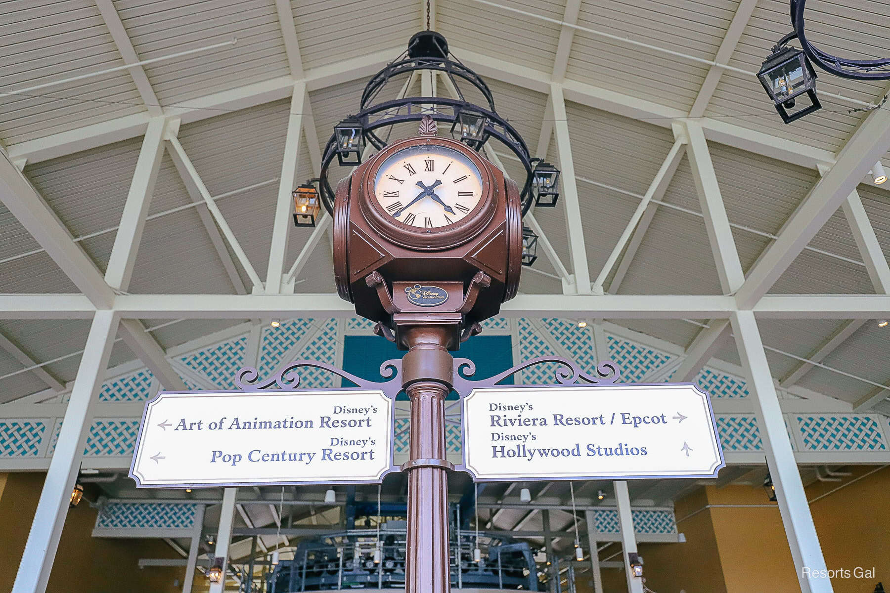 a directional for the skyliner on a sign with a clock