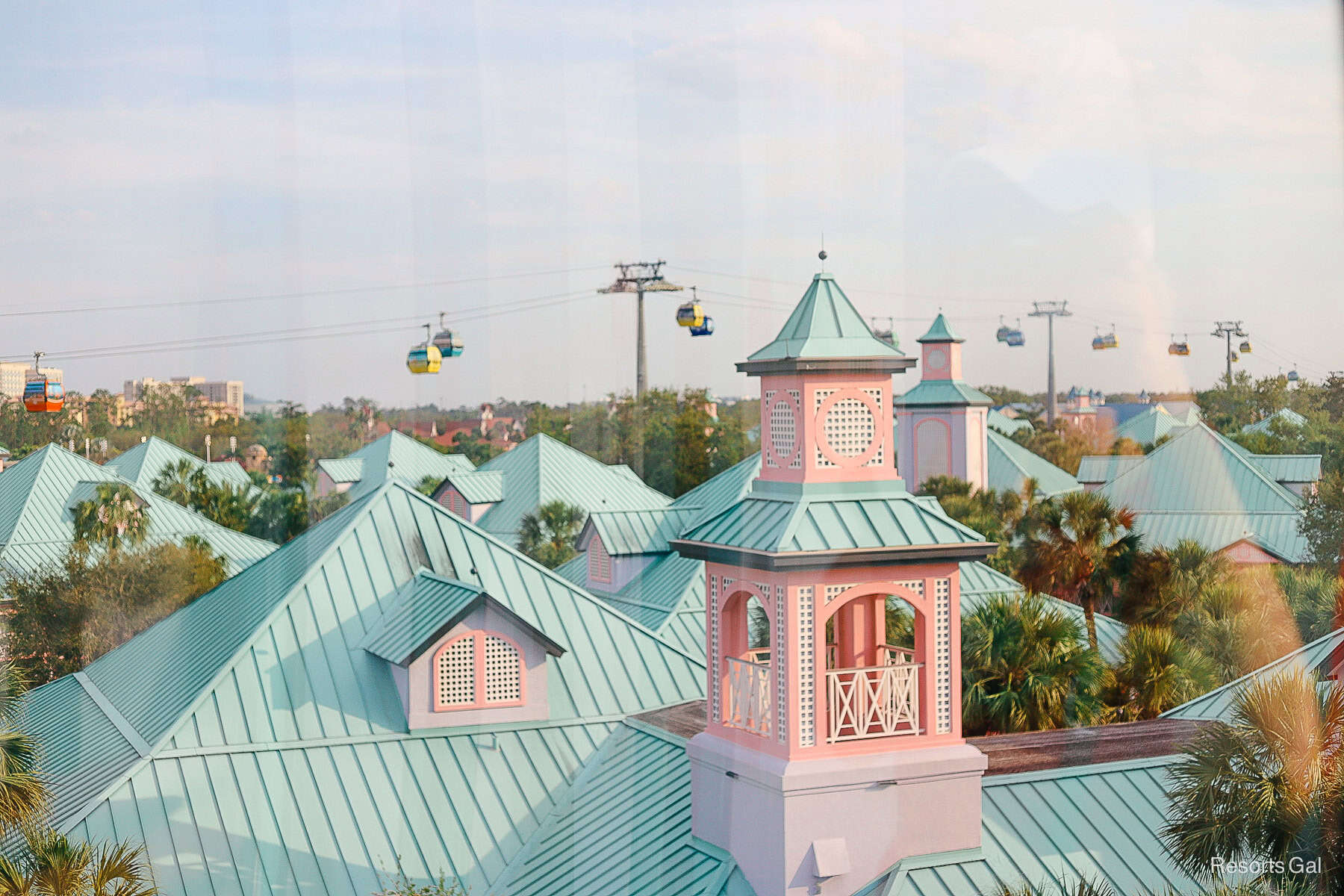 the Skyliner as it sails over the mint green and pink buildings of Caribbean Beach