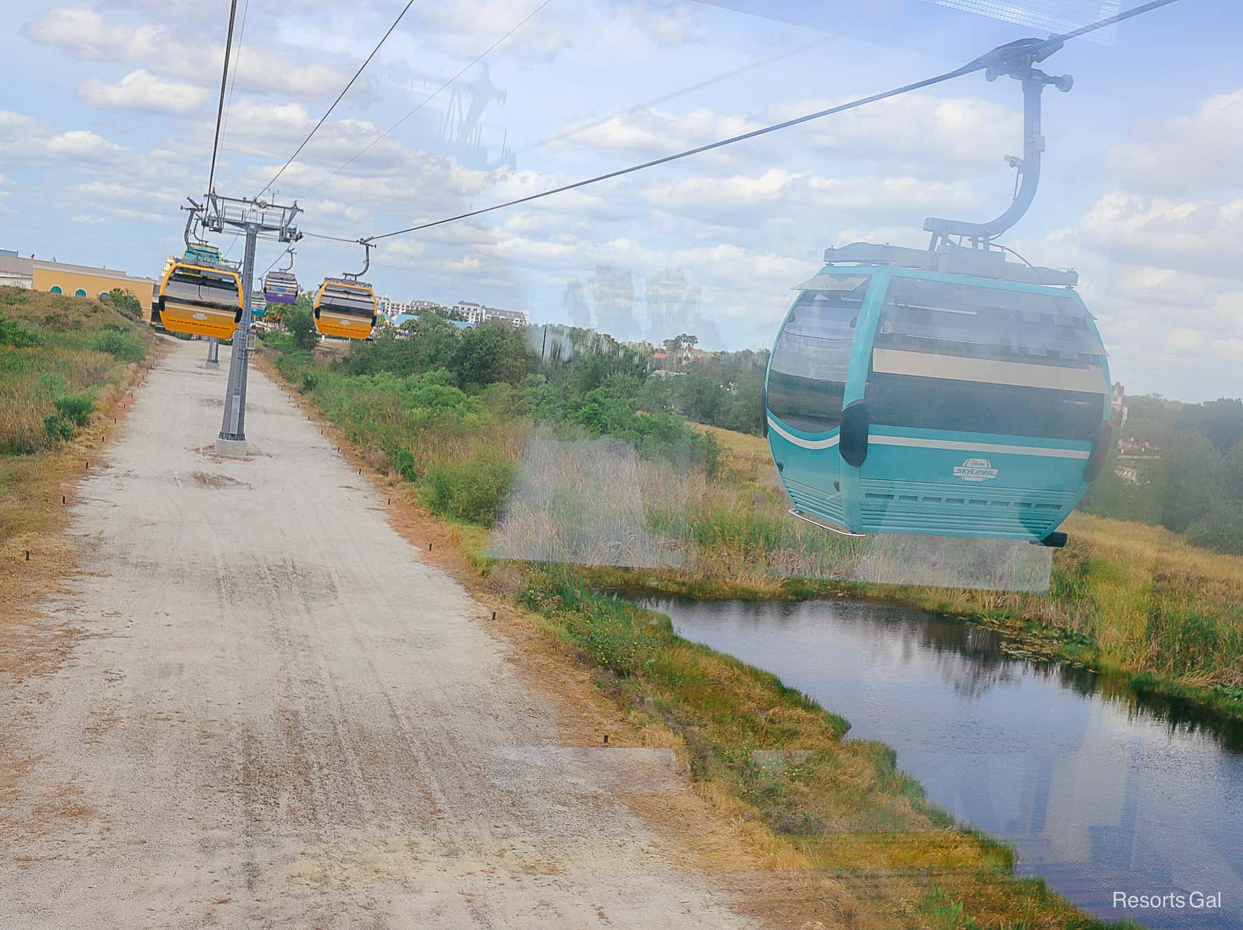 the Skyliner as it crosses over a gravel area between the value resorts and Caribbean Beach