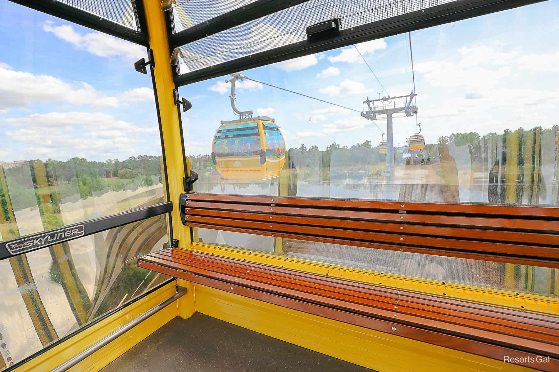 the interior of a yellow Skyliner as another one passes