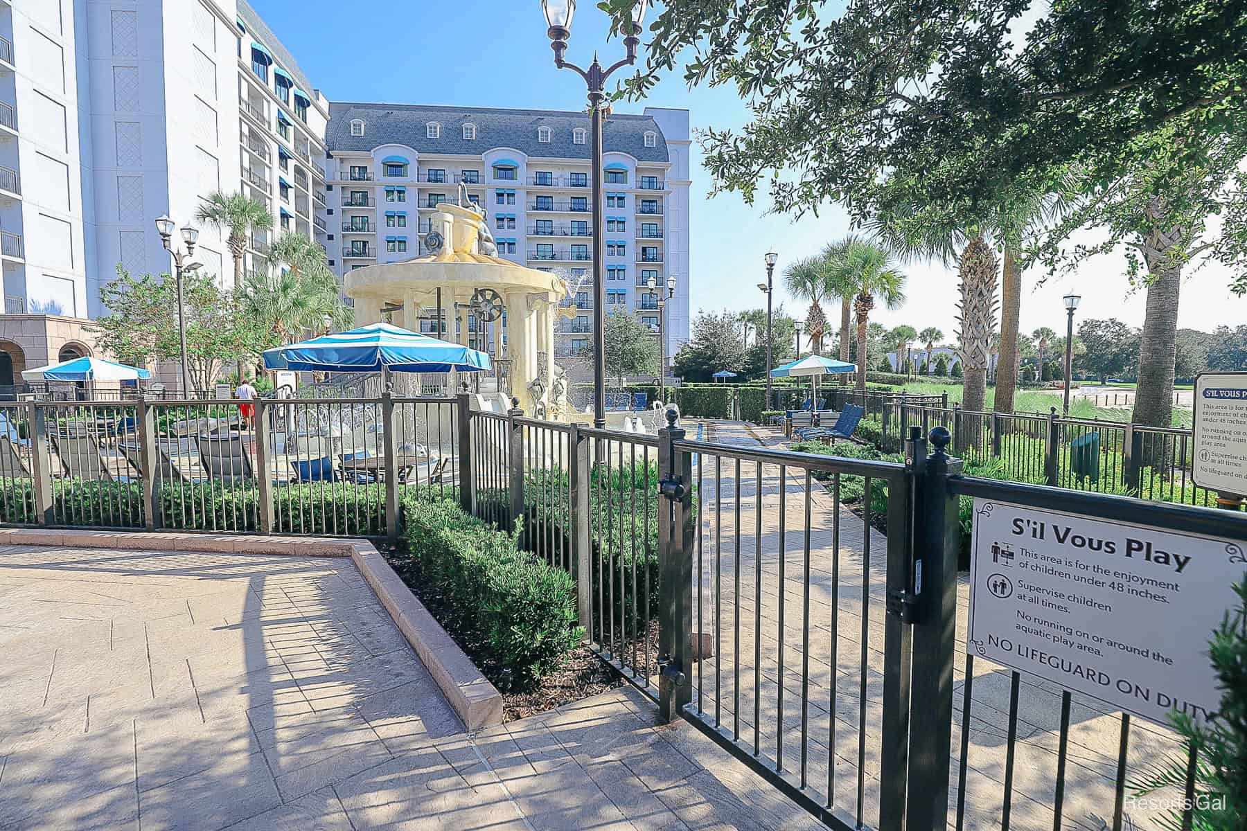a fence surrounds the S'il Vous Play aquatic play area 