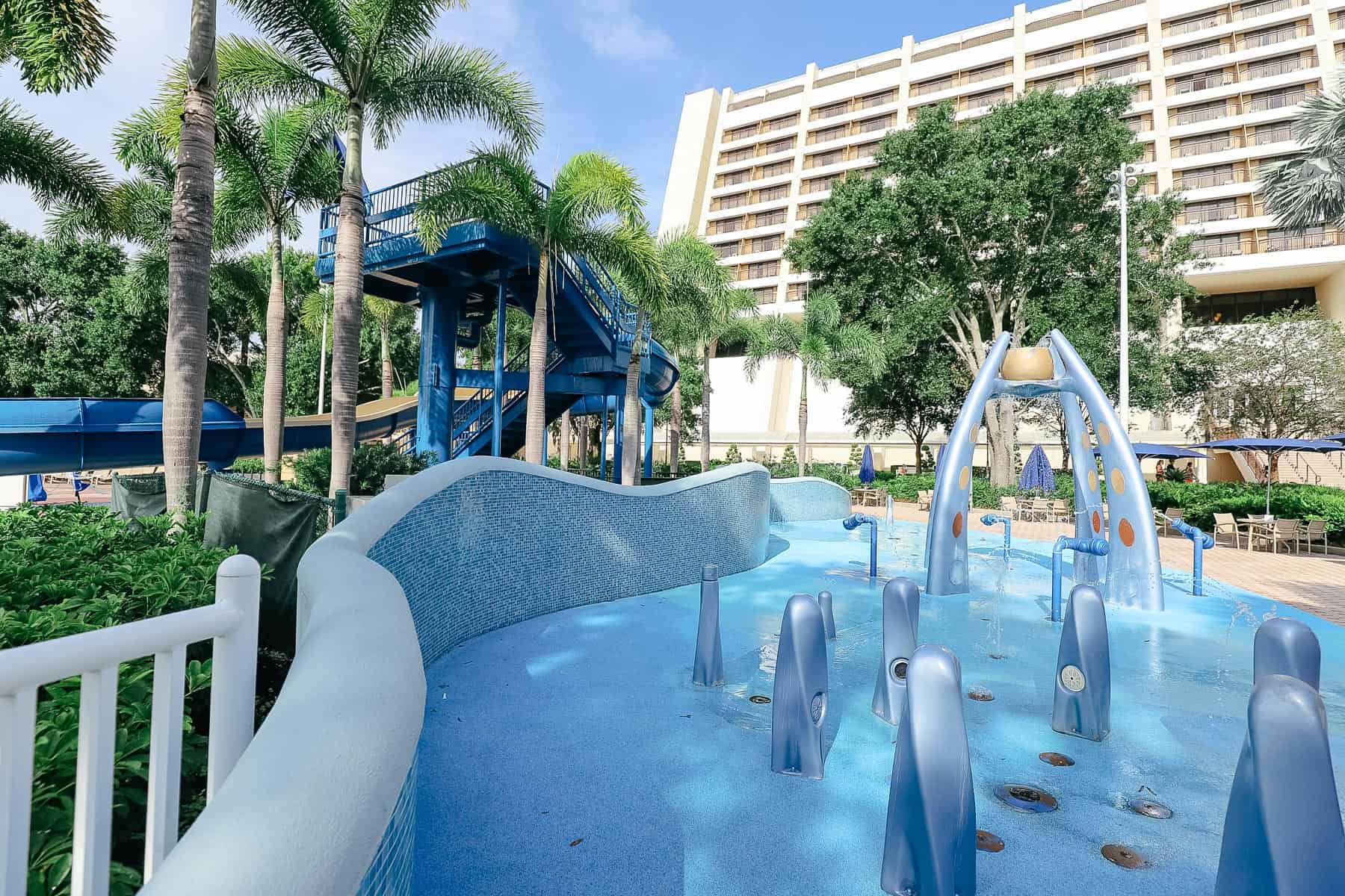 the splash pad is blue with lots of water sprayers 