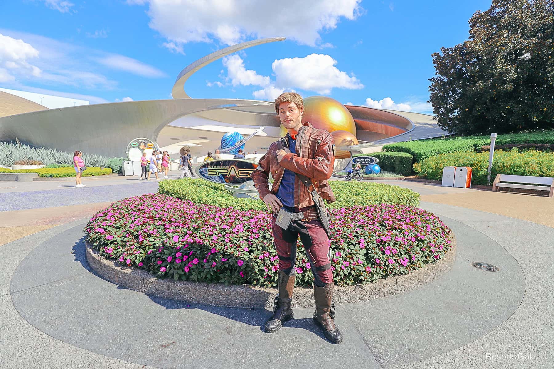 Peter Quil AKA Star-Lord poses for a photo in front of Mission Space at Epcot 