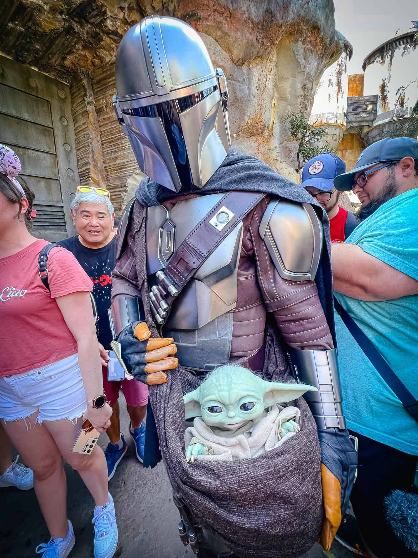 Grogu and The Mandalorian greeting guests in Galaxy's Edge at Disney World. 