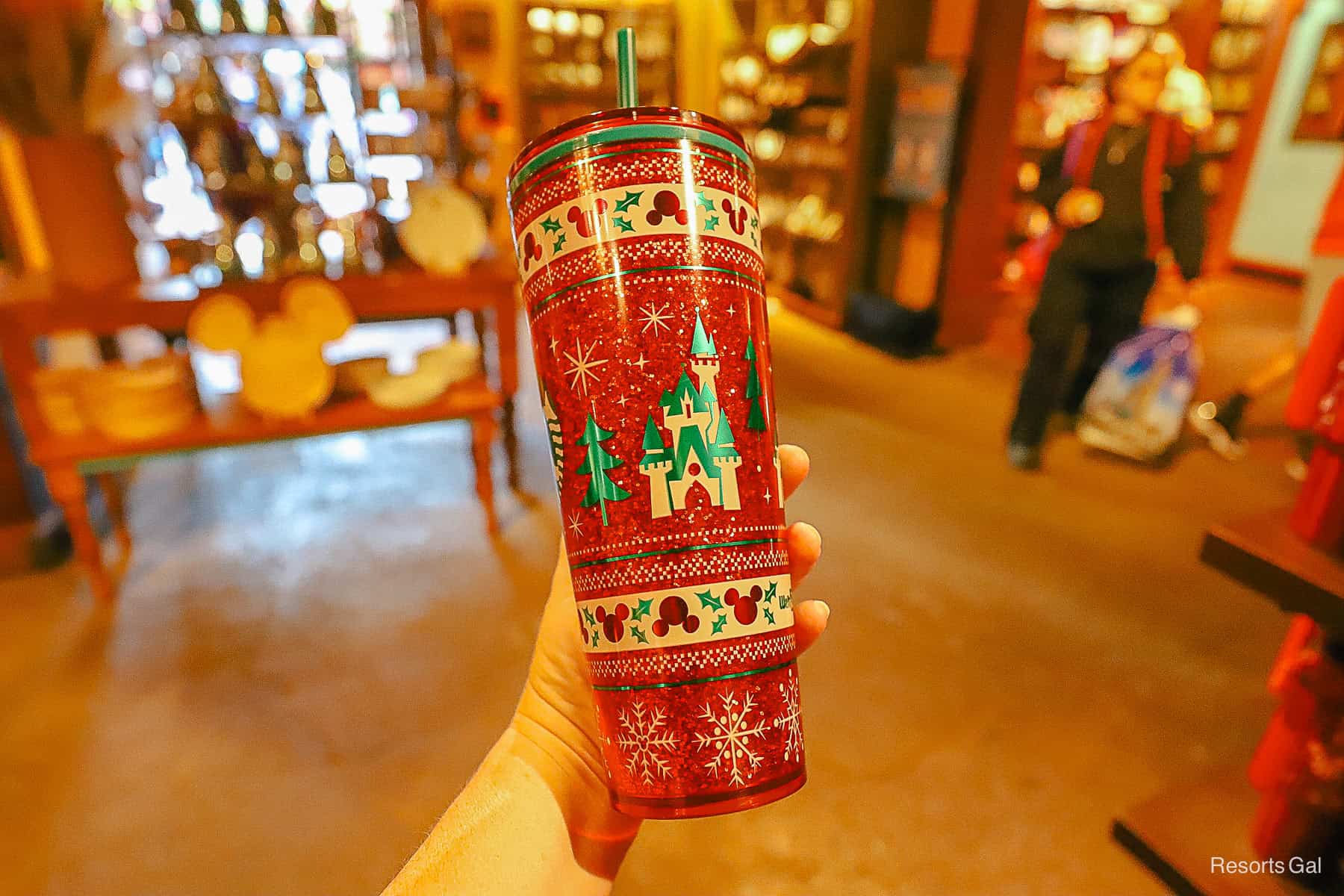 the opposite side of the glitter tumbler has a castle with a shiny green roof 