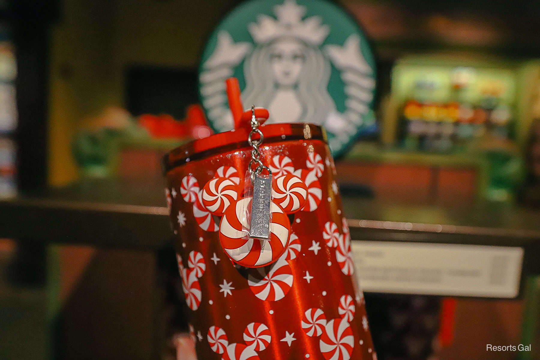 a peppermint Mickey charm hanging from the tumbler 
