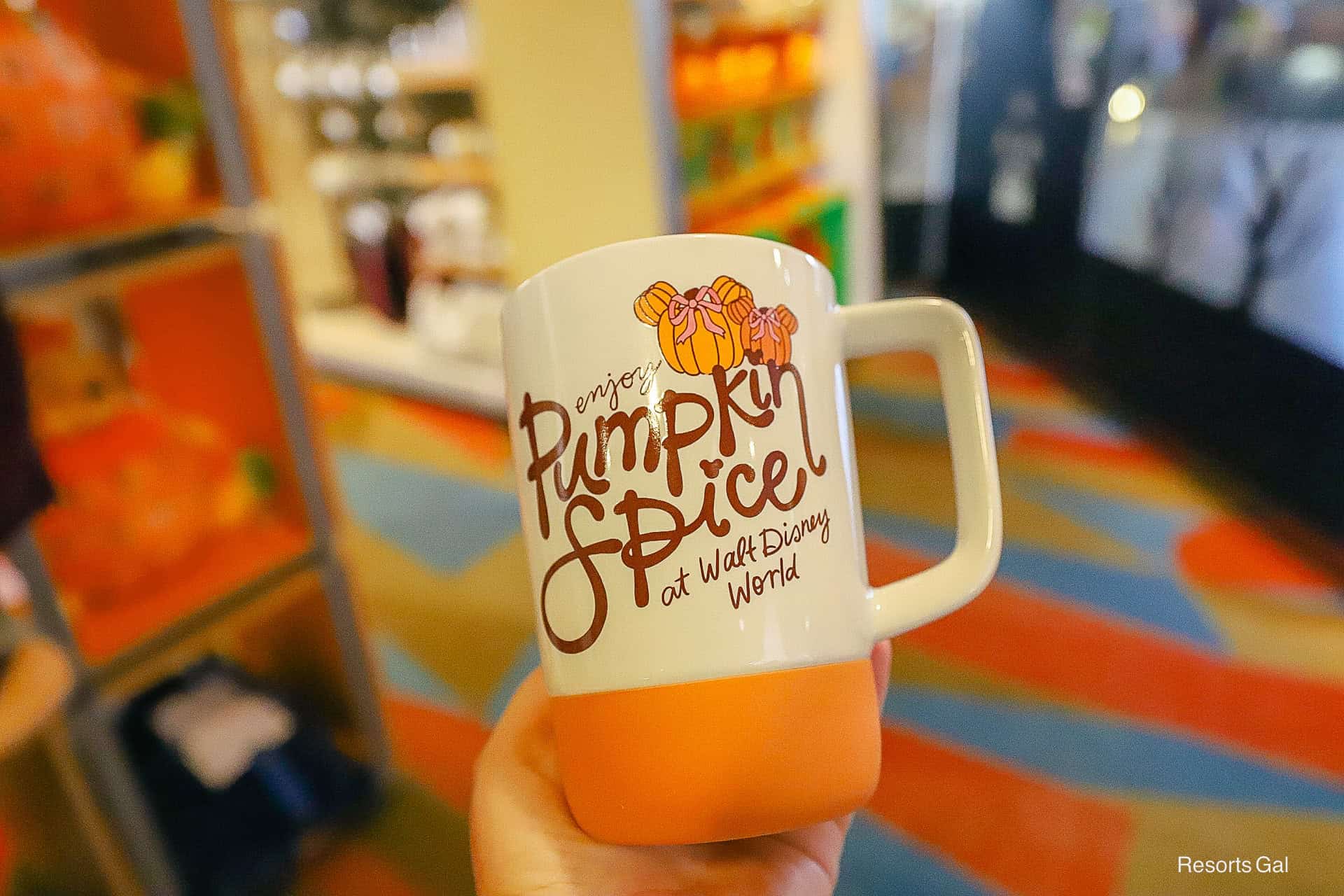 front of the Starbucks mug says: Enjoy Pumpkin Spice at Disney World