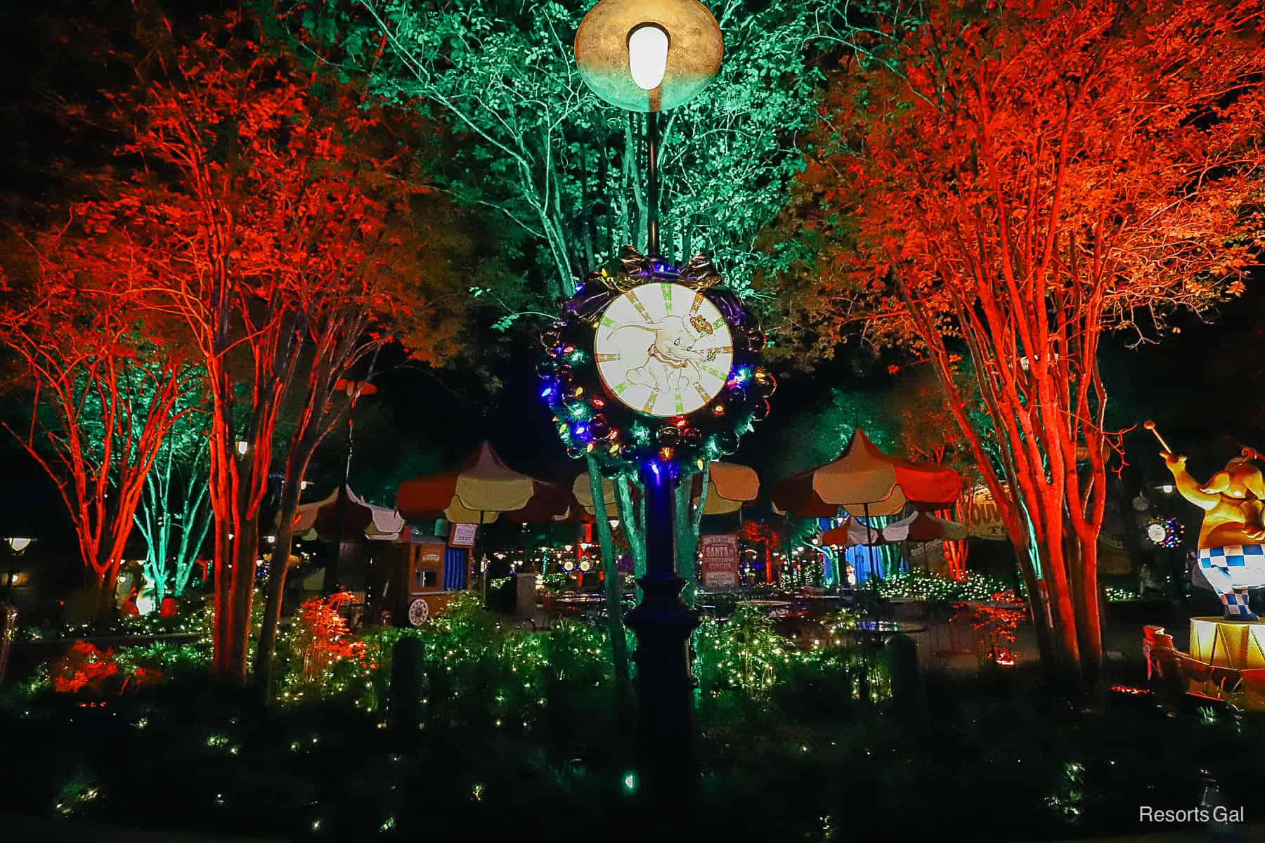 red, green, and a red tree with a Dumbo sign on a lamp pole