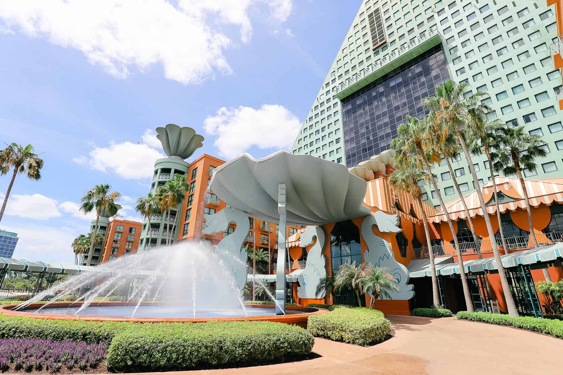 A fountain pouring from a clamshell in front of the Dolphin Hotel at Walt Disney World. 