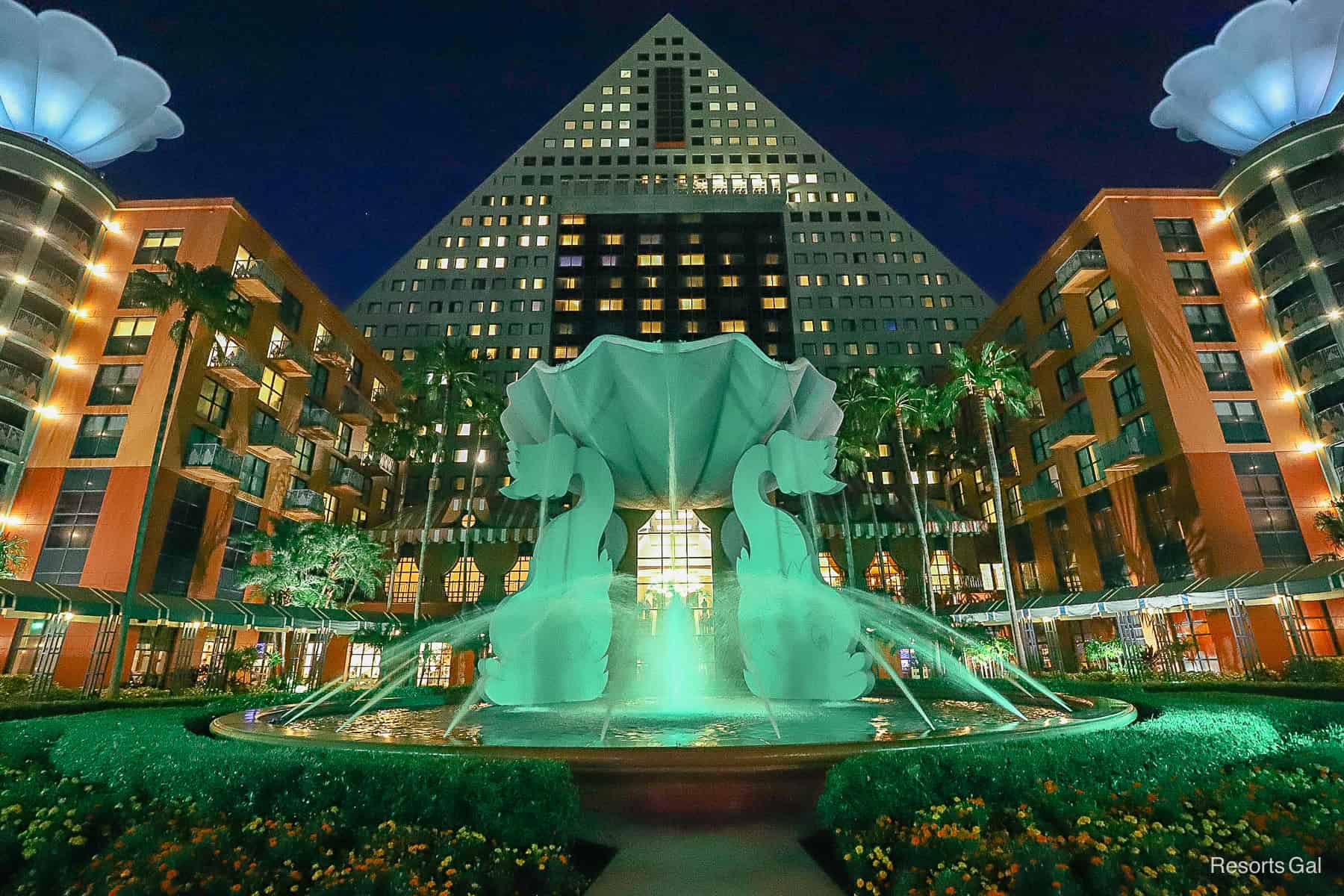 the Swan and Dolphin at night with green fountain