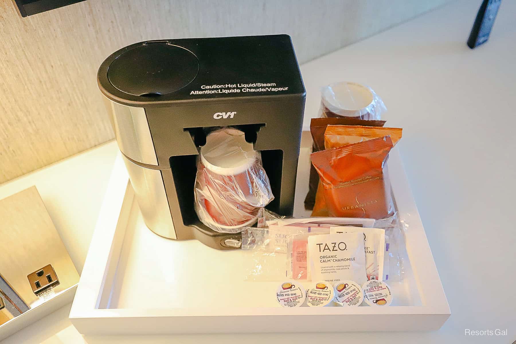 an in-room coffee maker with cups and selections
