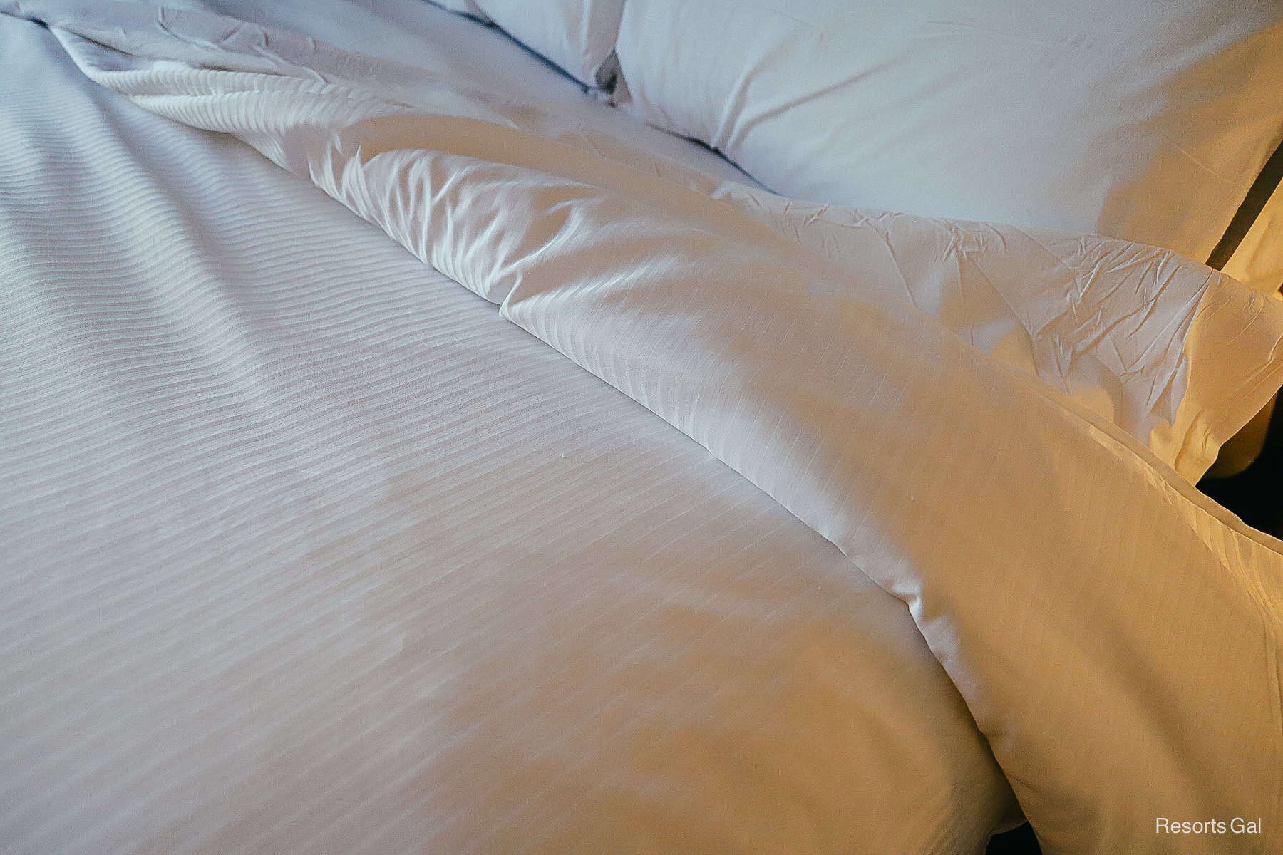 shows that the bed has a blanket instead of sheets 