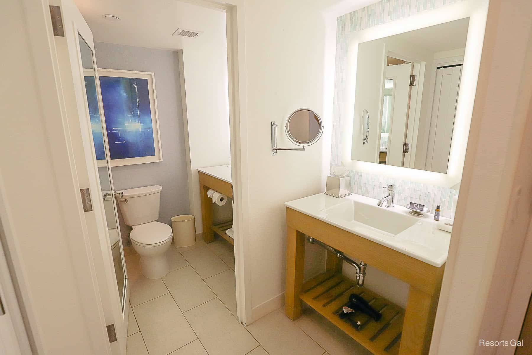 shows two vanities, one in the water closet and one in a separate area 