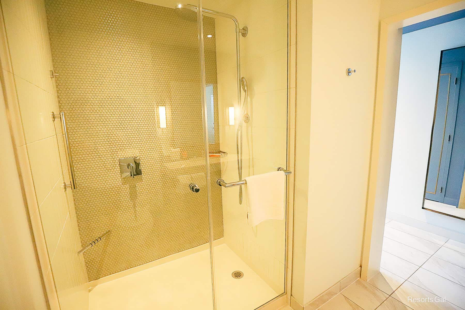 a walk-in shower with clear glass doors in the Swan Reserve bathroom