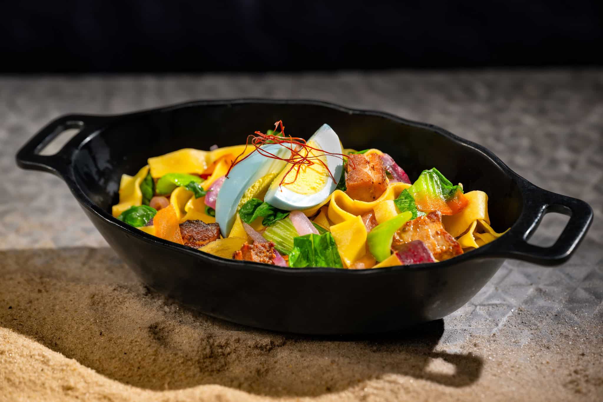 a dish called the Sweet and Spicy Puffer Pig Pasta topped with hard boiled egg