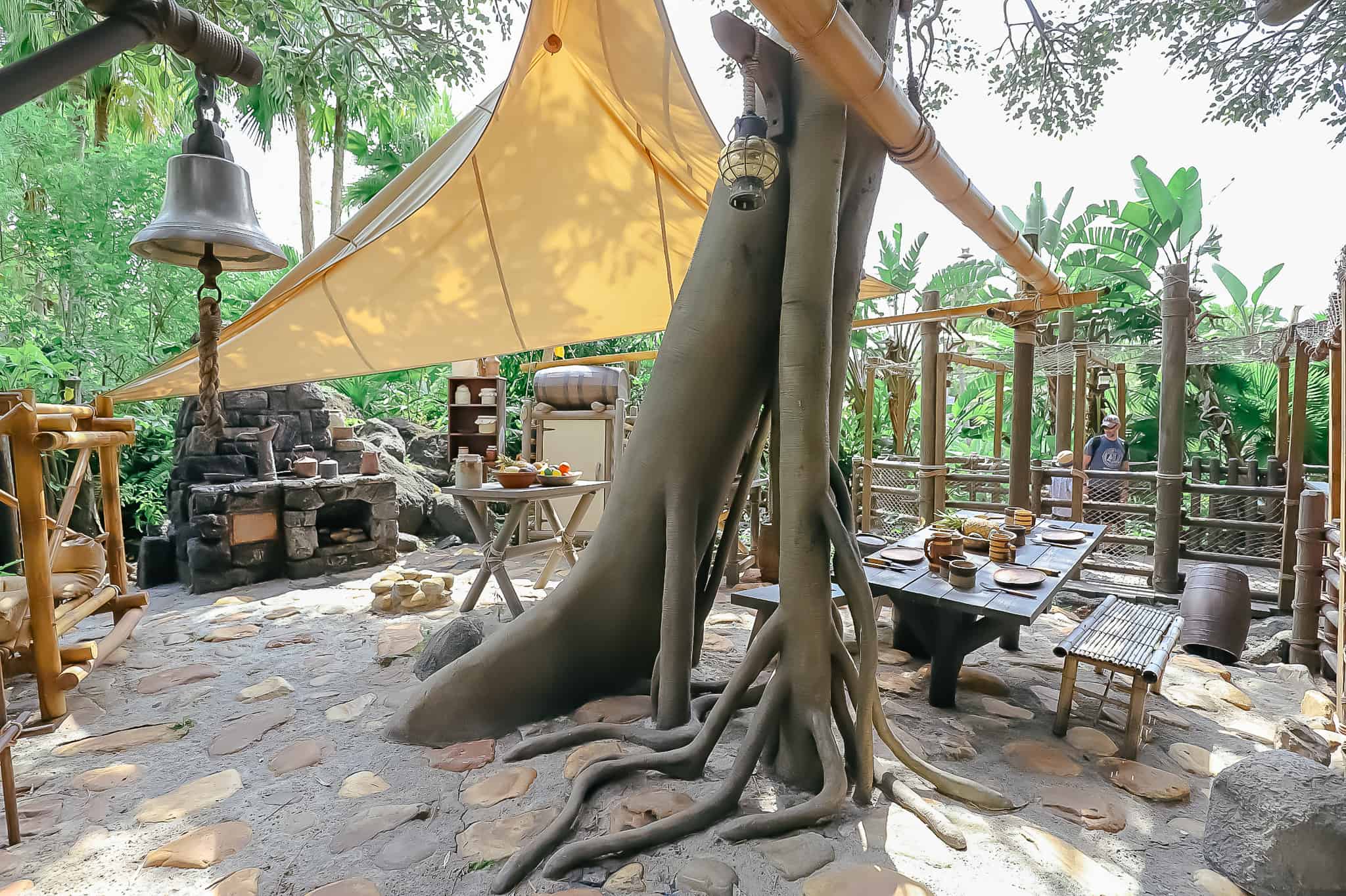 the kitchen with a dinner bell and stove made from rocks 